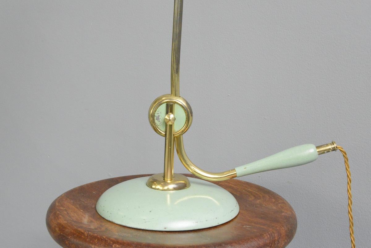 Midcentury table lamp by Helo, circa 1950s

- Original light green paint
- Curved brass arm
- Wooden handle to adjust the angle of the lamp
- Aluminium shade
- Takes E27 fitting bulbs
- On/Off switch on the cable
- Produced by Helo
-