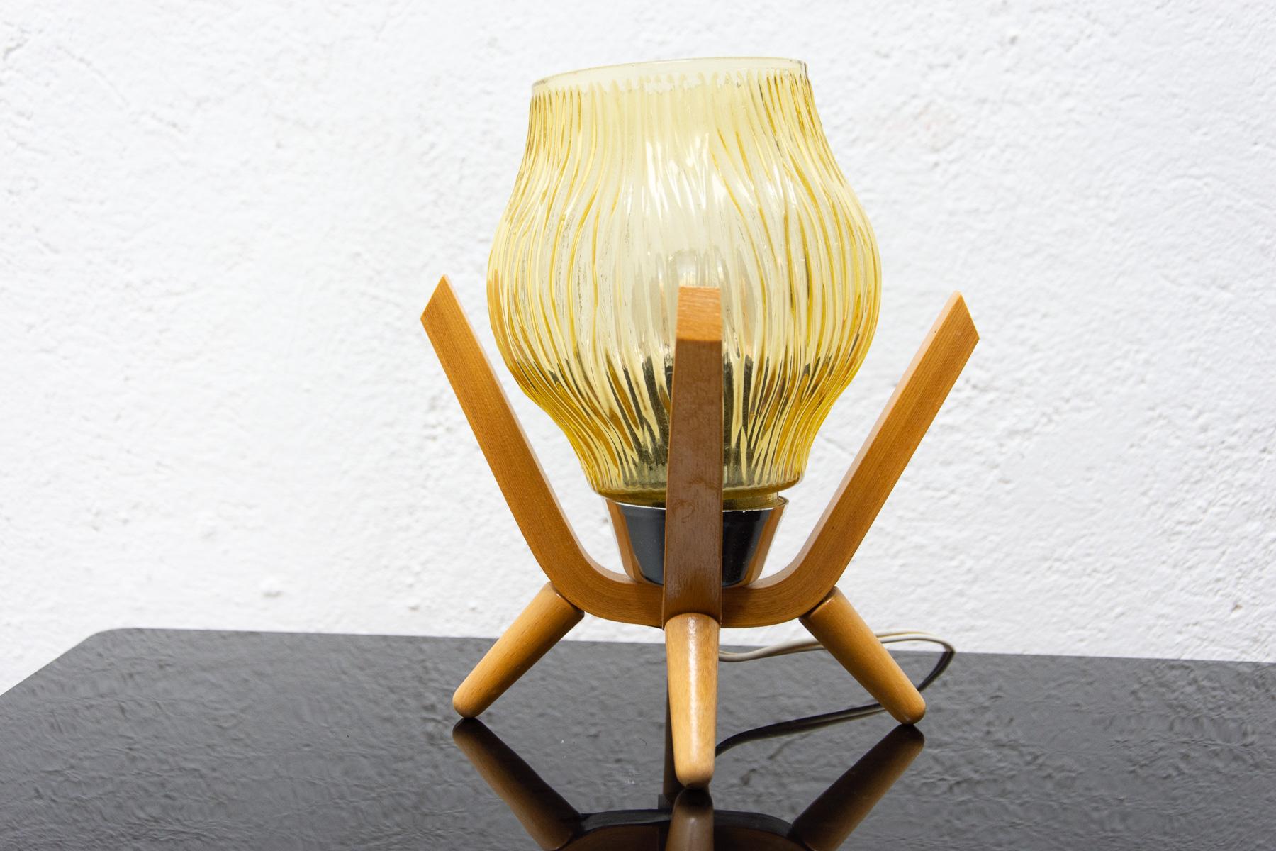 This mid century table lamp was made by the Czechoslovak company Drevo Humpolec in the 1960s.
The lamp has a wooden base and a glass shade.
It’s in very good vintage condition, fully functional.
 