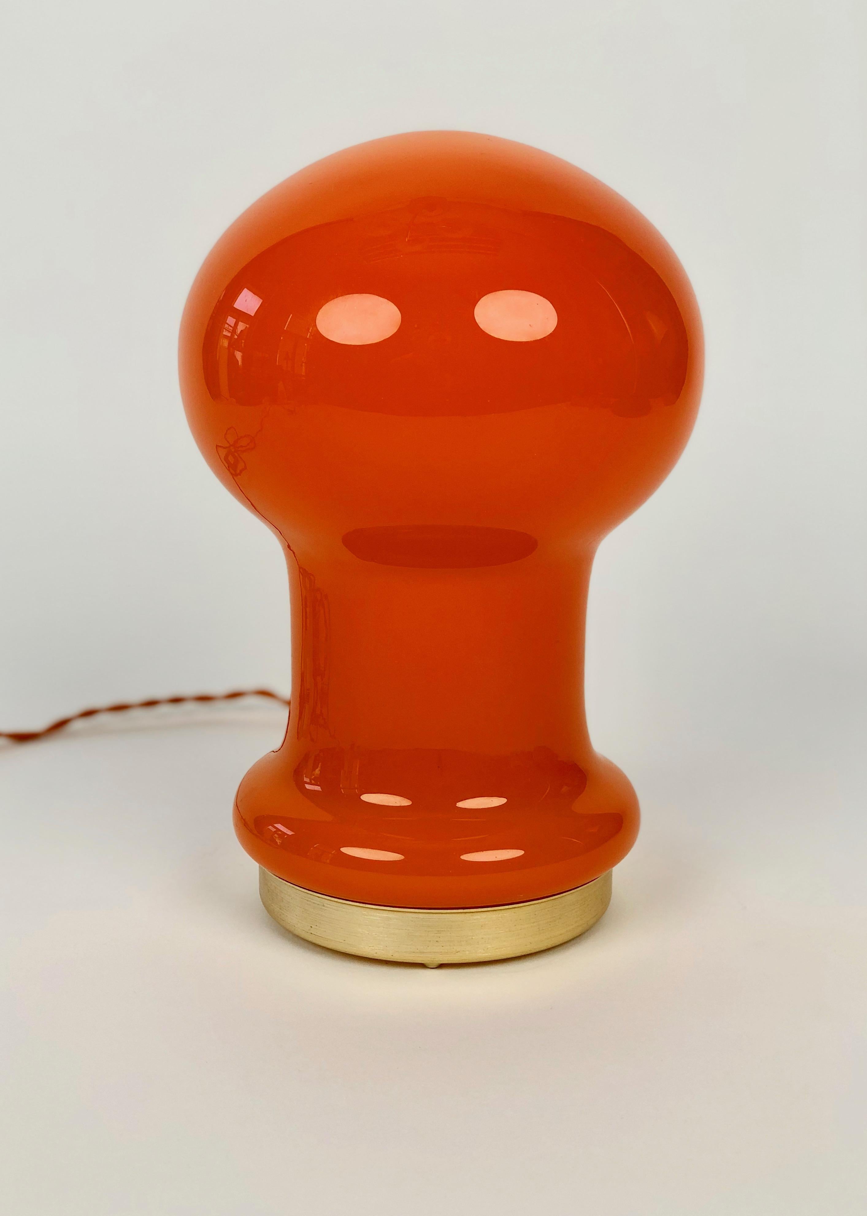 A beautiful orange, opaline glass table lamp produced by OPP Jihlava and designed by Štepán Tabery in the 1970's in Czechoslovakia.

The metal base is made from  brass coloured aluminium;  the new silk cable in orange, gives the lamp a funky