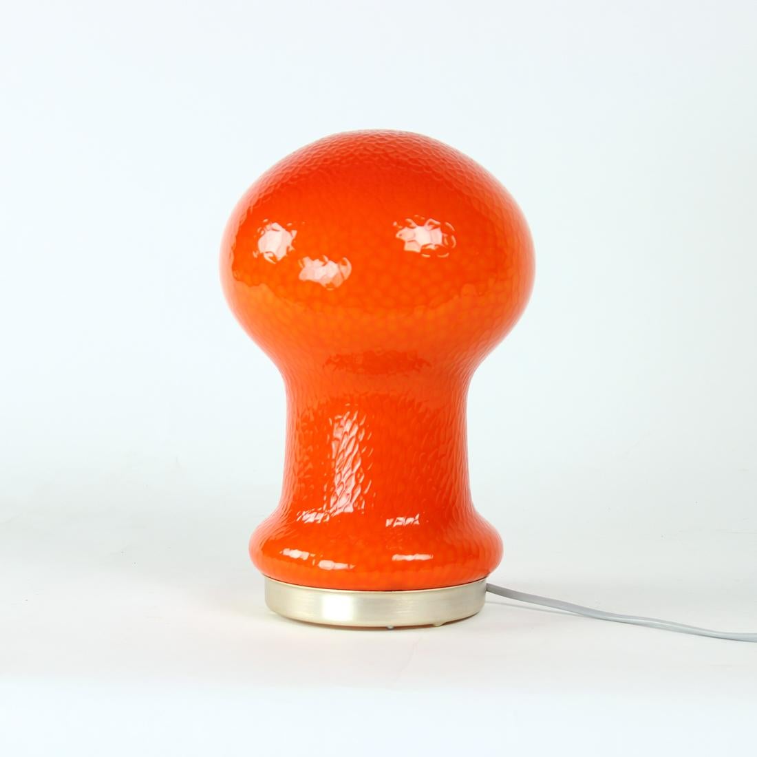 Beautiful table lamp produced by OPP Jihlava and designed by Stefan Tabery in 1960s. The lamp is made of orange opaline glass with a leather like finish on the lamp. The base is made of aluminum. Beautiful lamp and in excellent condition without any