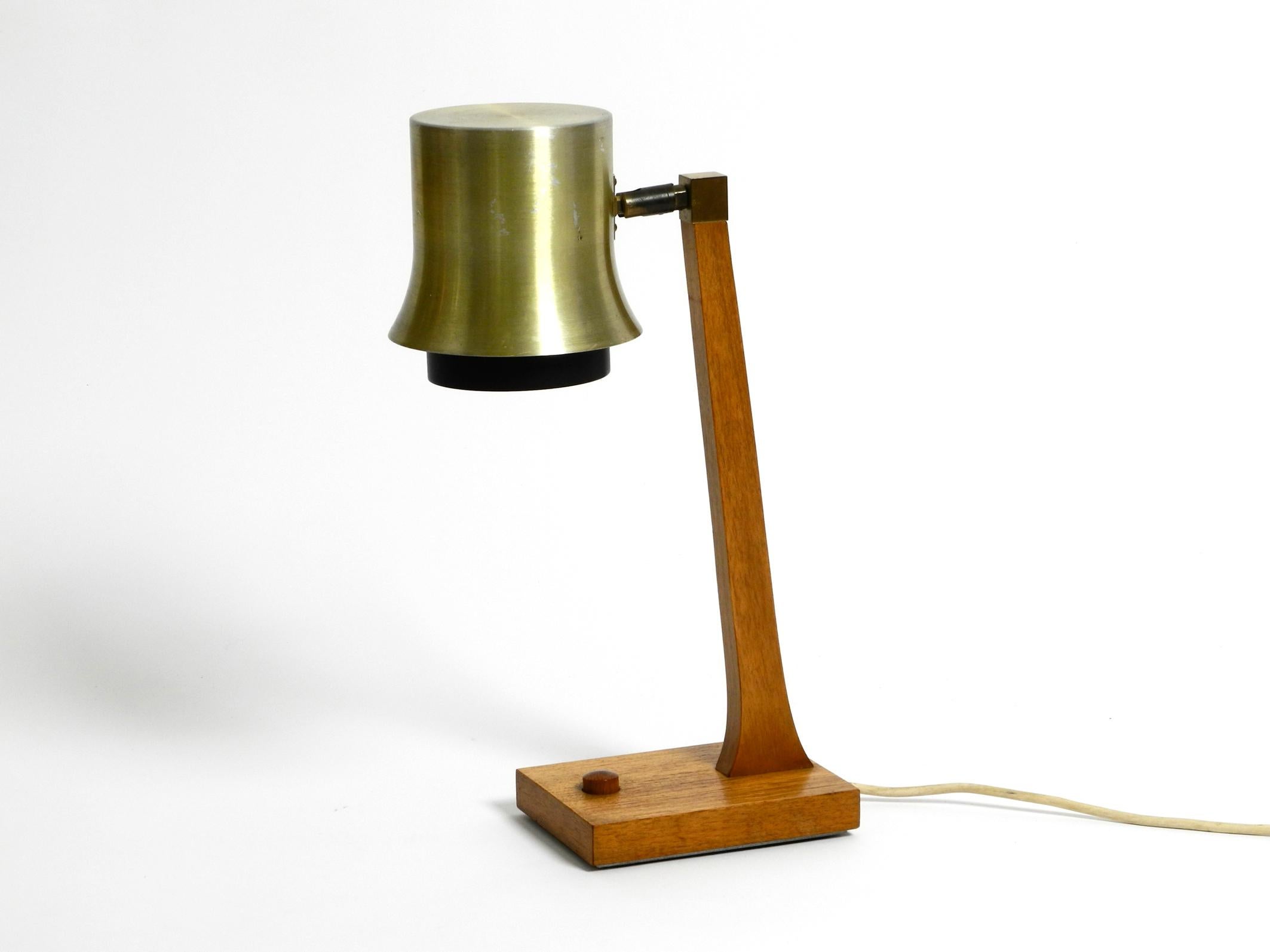 Extraordinary mid-century table lamp made of teak and with aluminum shade. Great Scandinavian design. Made in Denmark. Very high quality processing.
Base and neck are made of solid teak, even the switch on the base is made of teak.
The shade is