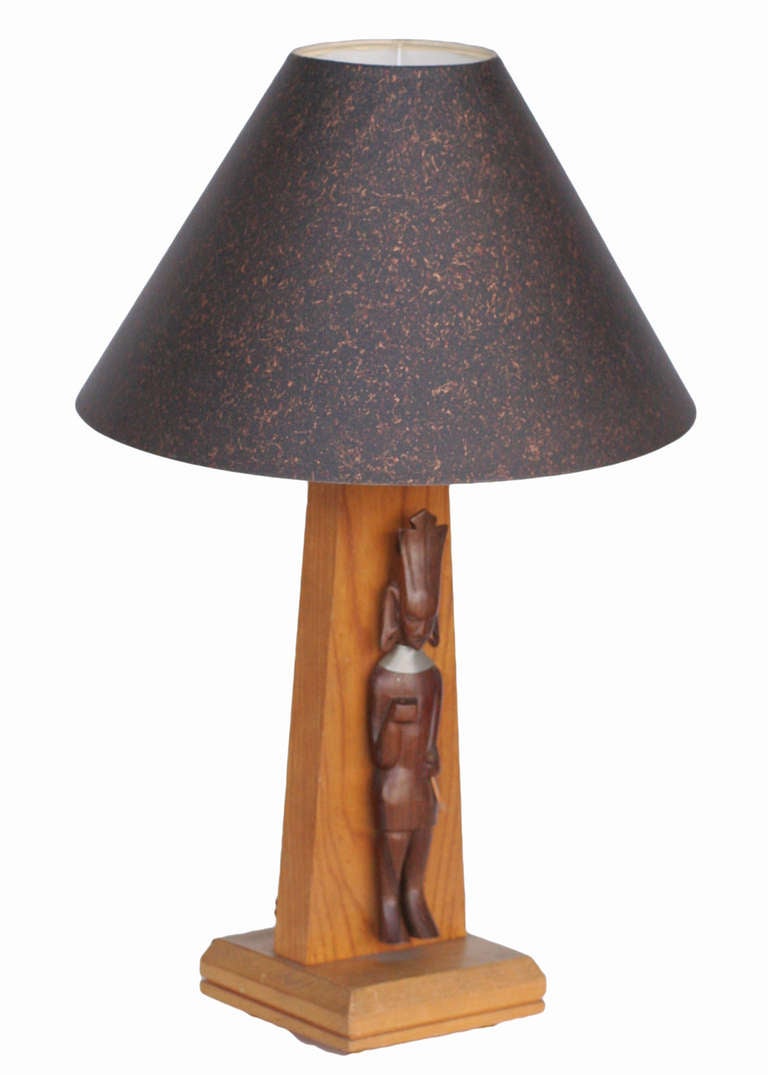 Mid-century table lamp with hand carved African figural accents, circa 1950.

  