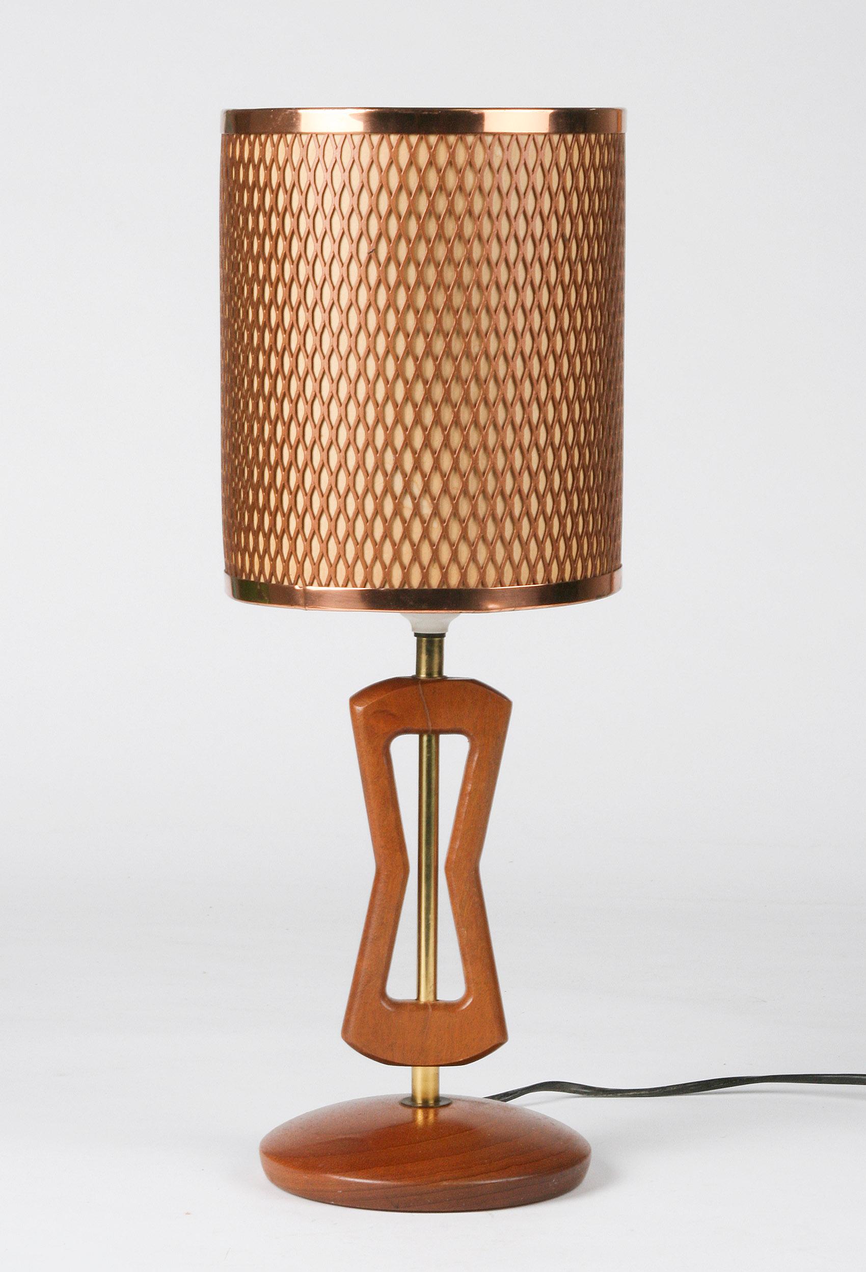Nice table lamp made of beechwood with a copper openwork lampshade.
It is typical Scandinavian design.
Maker is unknown.