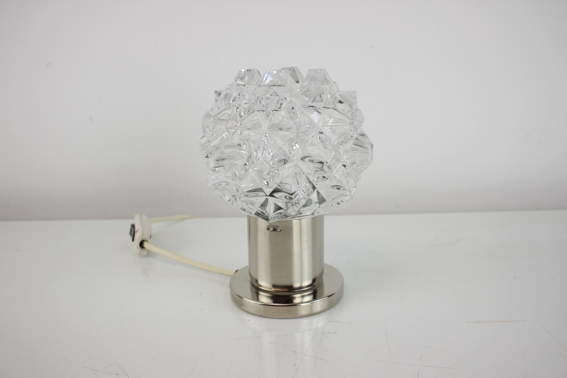 Vintage  table lamp or bedside lamp. Can also be used as wall lamp. Produced by famous Kamenicky Senov Glassworks in former Czechoslovakia in the 1960s. 
Bulb: 1 x E14. US plug adapter included.