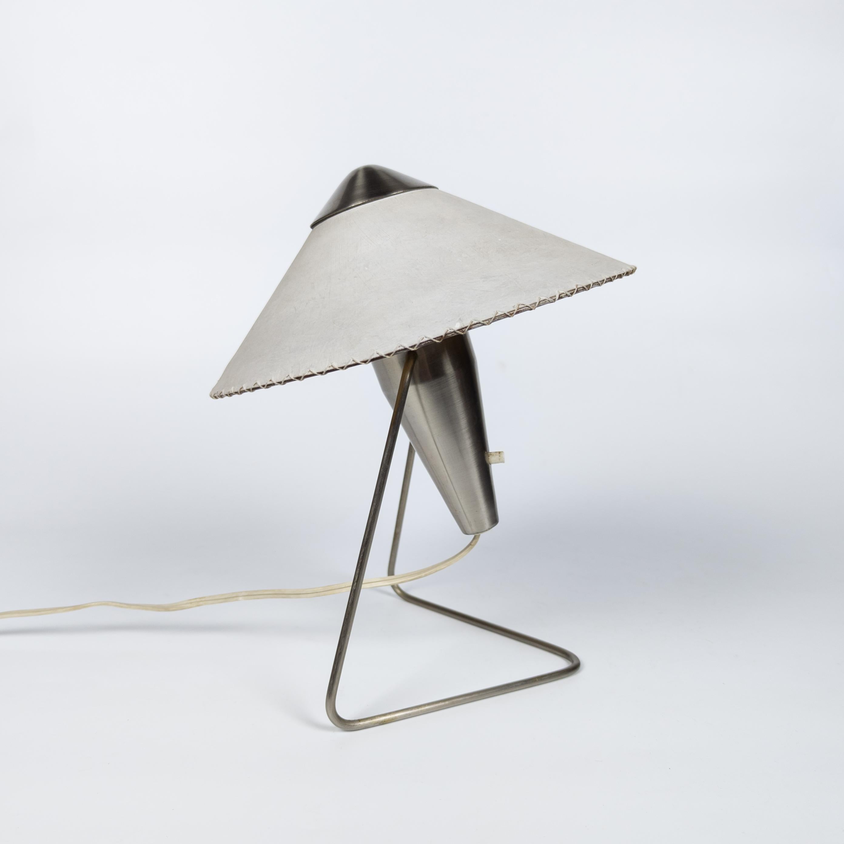 Small table or wall lamp created by Czech designer Helena Frantová in 1953. The lamp has a simple, modernist yet sophisticated design. The body of the lamp is made of nickel plated steel. The round lamp shade with a shape reminiscent of the