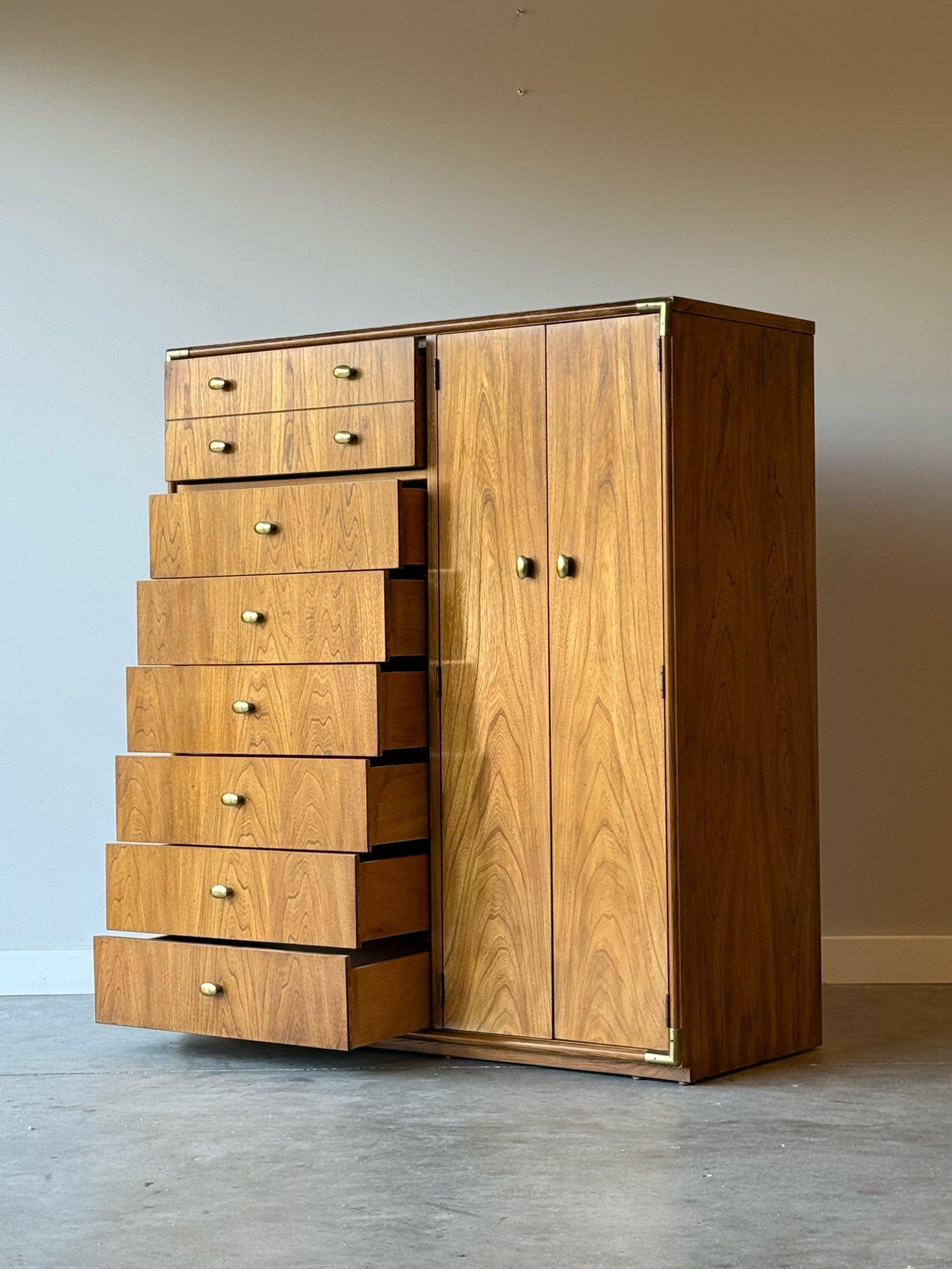 Vintage tall dresser manufactured by Stanley Furniture. A perfect solution for those looking for ample storage without taking up a large footprint. The stylings of this dresser combine the rustic sensibilities and brass corners of the campaign style