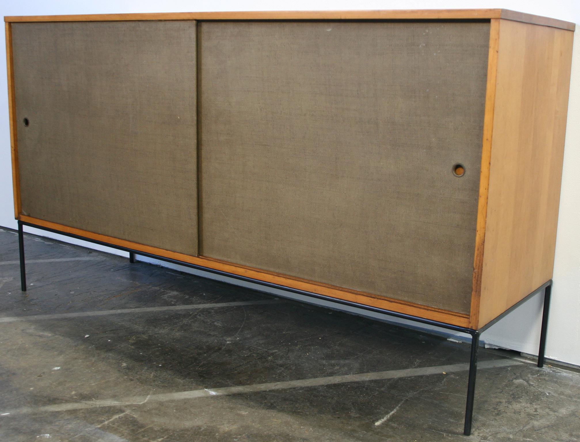 Beautiful midcentury tall credenza by Paul McCobb circa 1950 Planner Group #1514 has 1 adjustable shelves w/pins with 1 drawer on the left side and 3 drawers on the right side. Solid maple construction has a light tobacco finish. All original