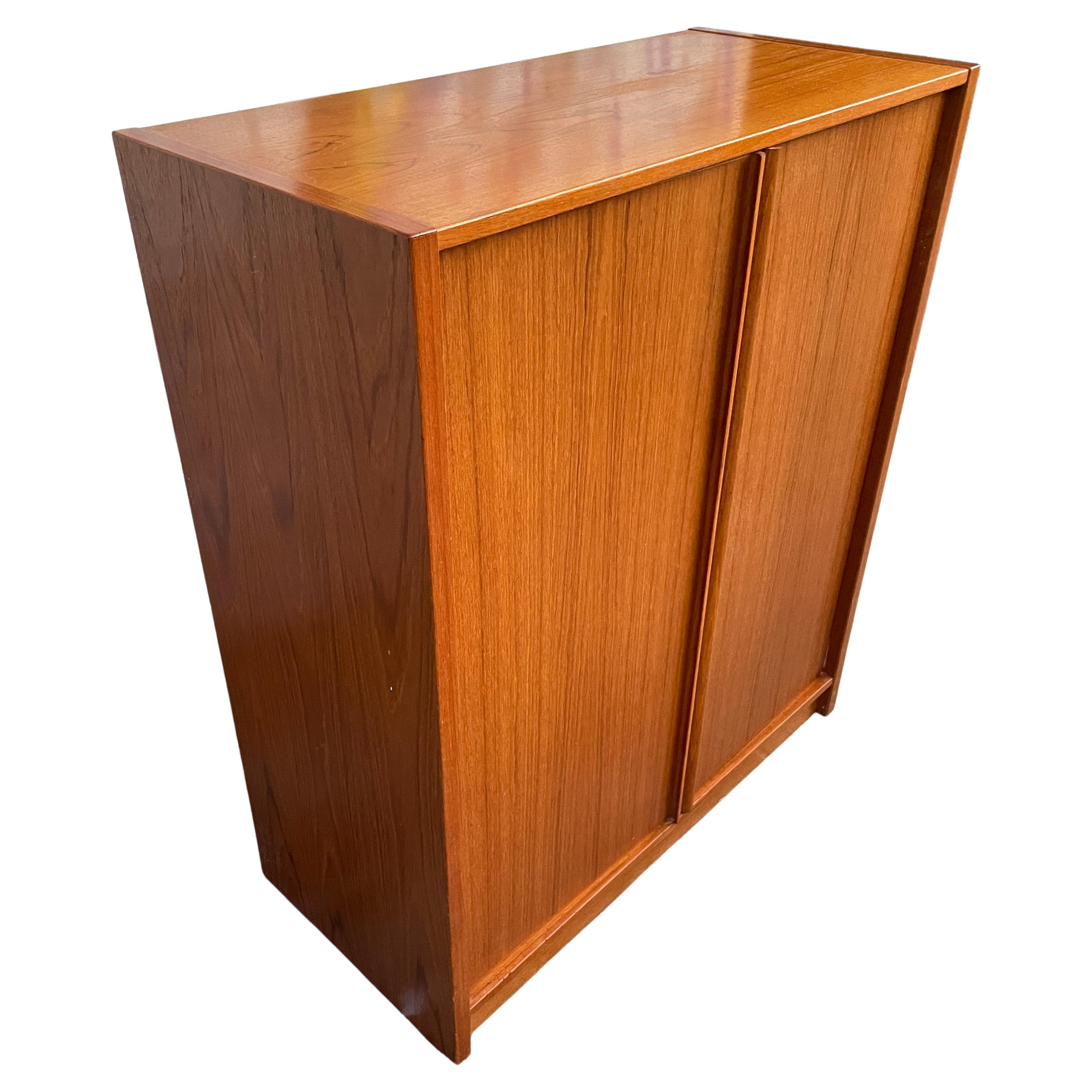 Beautiful mid-century tall teak dresser wardrobe 6-drawer on left and 3 shelves on the right behind 2 beautiful cabinet doors. Clean inside and out all drawers slide smooth. Made in Denmark. Very Good vintage condition. Located in Brooklyn NYC.