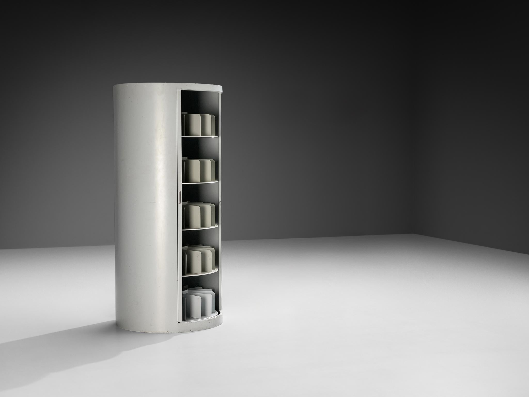 Filing cabinet, lacquered steel, metal, Germany, 1960s 

This filing cabinet from the 1960s is unusual because of its cylindrical shape. Instead of the usual boxy, rectangular form we expect from office storage, it stands like a tall, rounded