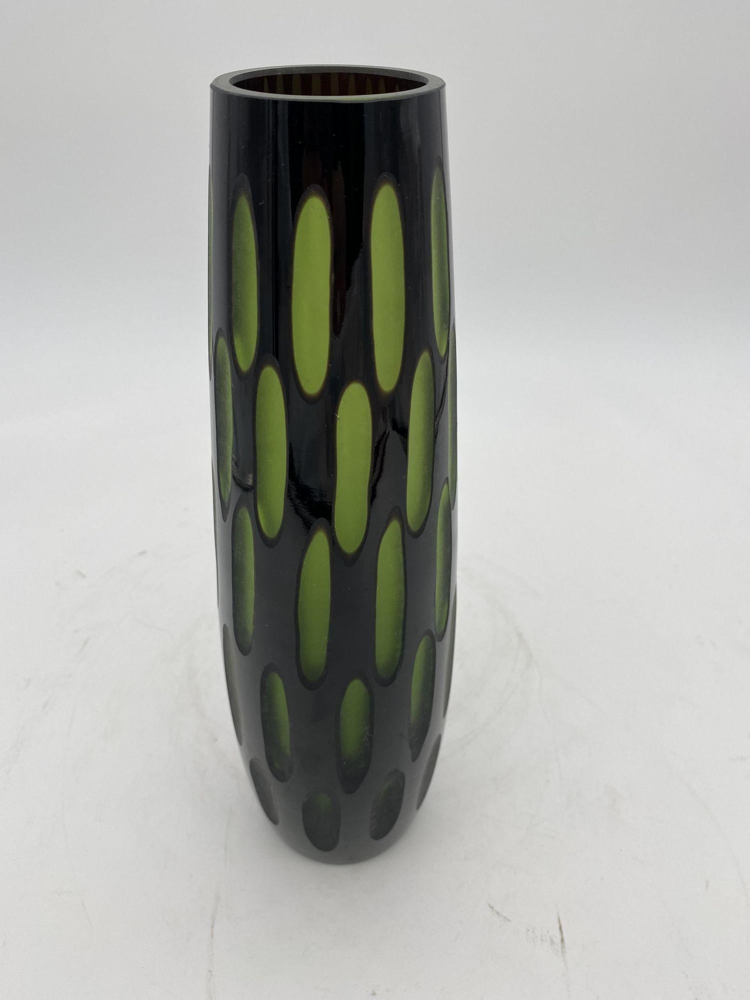 Original 1960s two-tone black/green cut two-layered Murano glass vase. The vase features a black outer color and green inner layer which appears to almost when hit by the light. The slender tall form will bring a whimsical flair to any room.

1960,