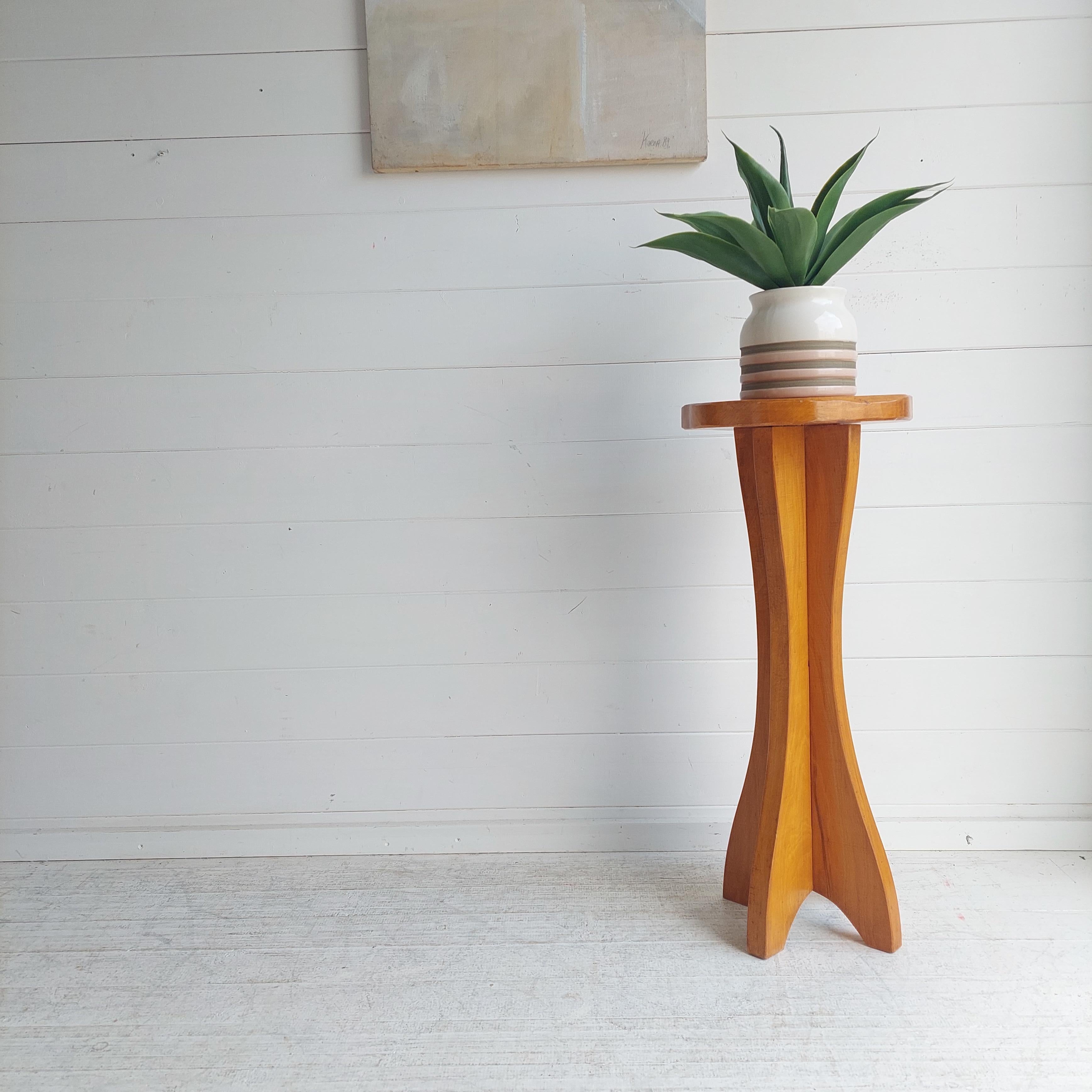 A beautifully  solid carved  torchere / plant table. 
This was made in England in the mid century  period, it dates from around 1950s.

A tall mid century side table, which were likely hand-made.
One of a kind pedestal, unlikely to find any other