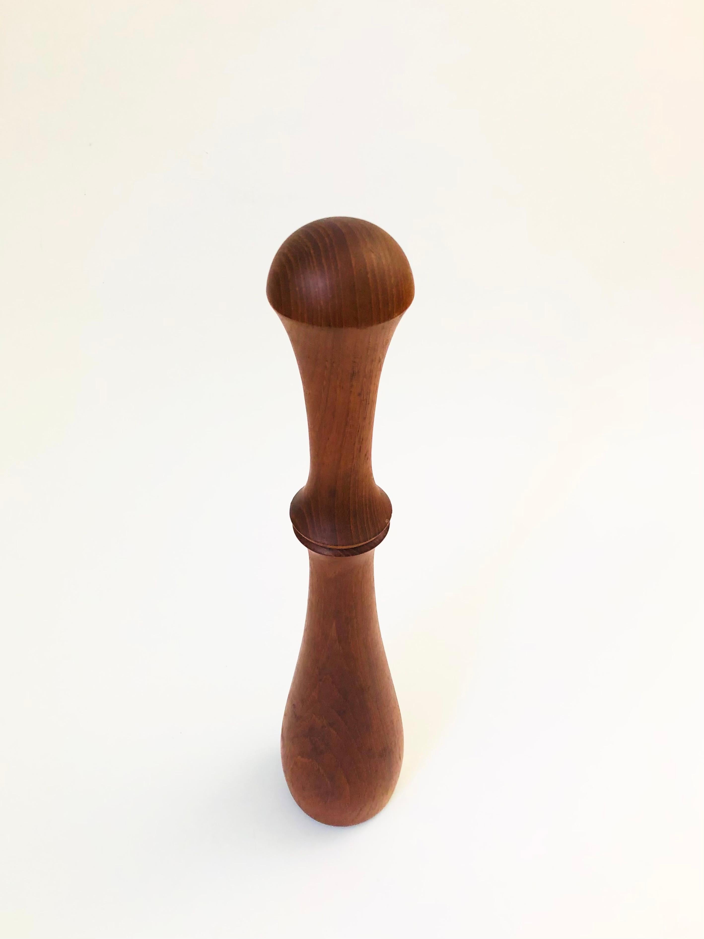 A tall mid century Danish teak Peppermill designed by Jens Harald Quistgaard for Dansk. Beautiful minimalist design out of smooth turned wood. The plastic grinder in the base is marked with Jens Quistgaards initials 