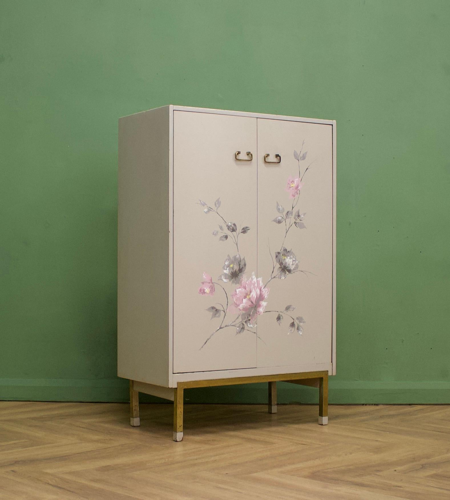 A mid century cupboard chest / linen cabinet - designed by VB Wilkins for G Plan - 1960's
Featuring a factory painted clematis flower design
Internally there are two drawers and two shelves
The legs are metal 
