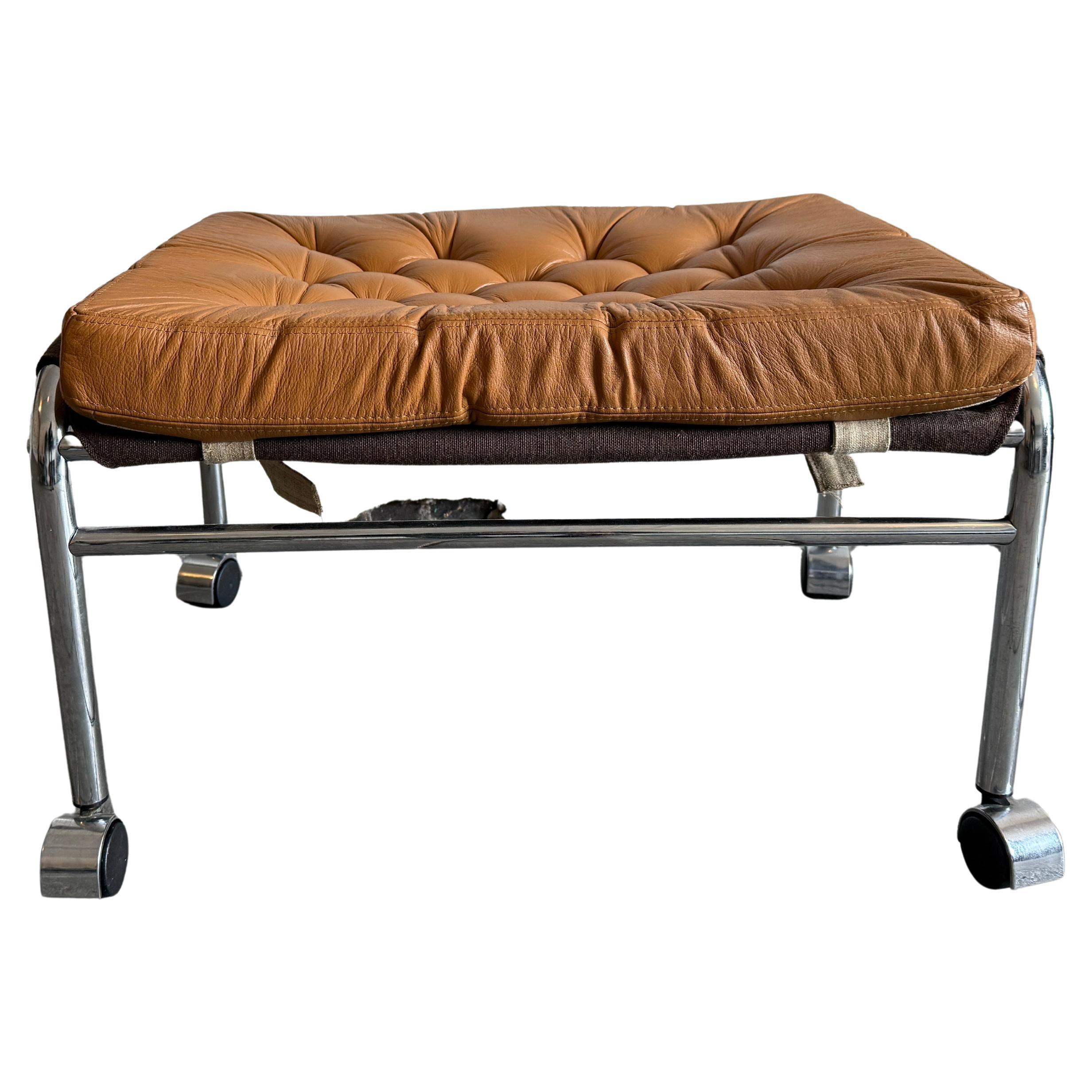 Mid Century Tan Leather tufted chrome ottoman with casters by DUX