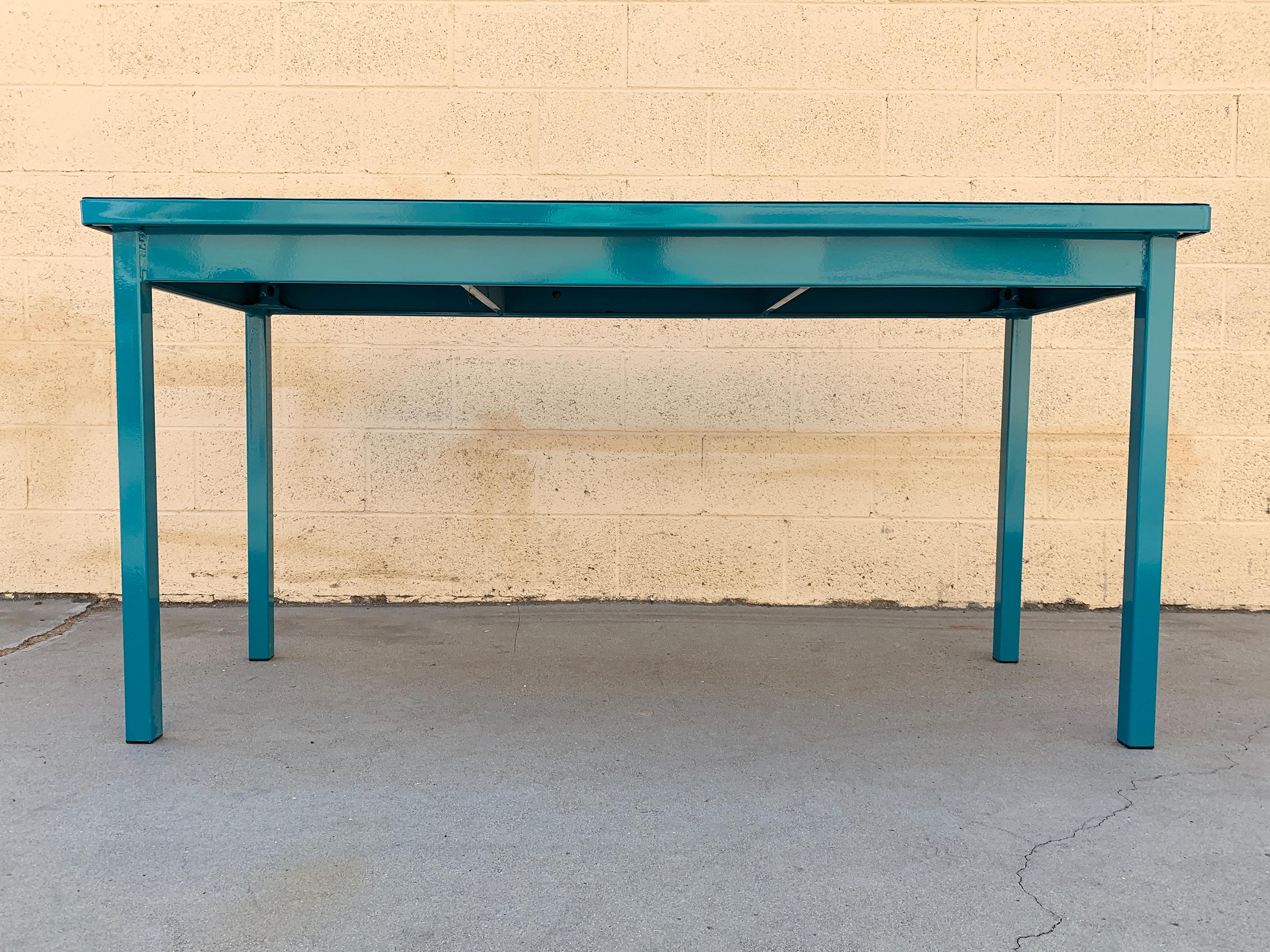 Midcentury 4-legged tanker table refinished in a pop of teal (RAL 5021). This table is narrower and wider than most tankers; at 24