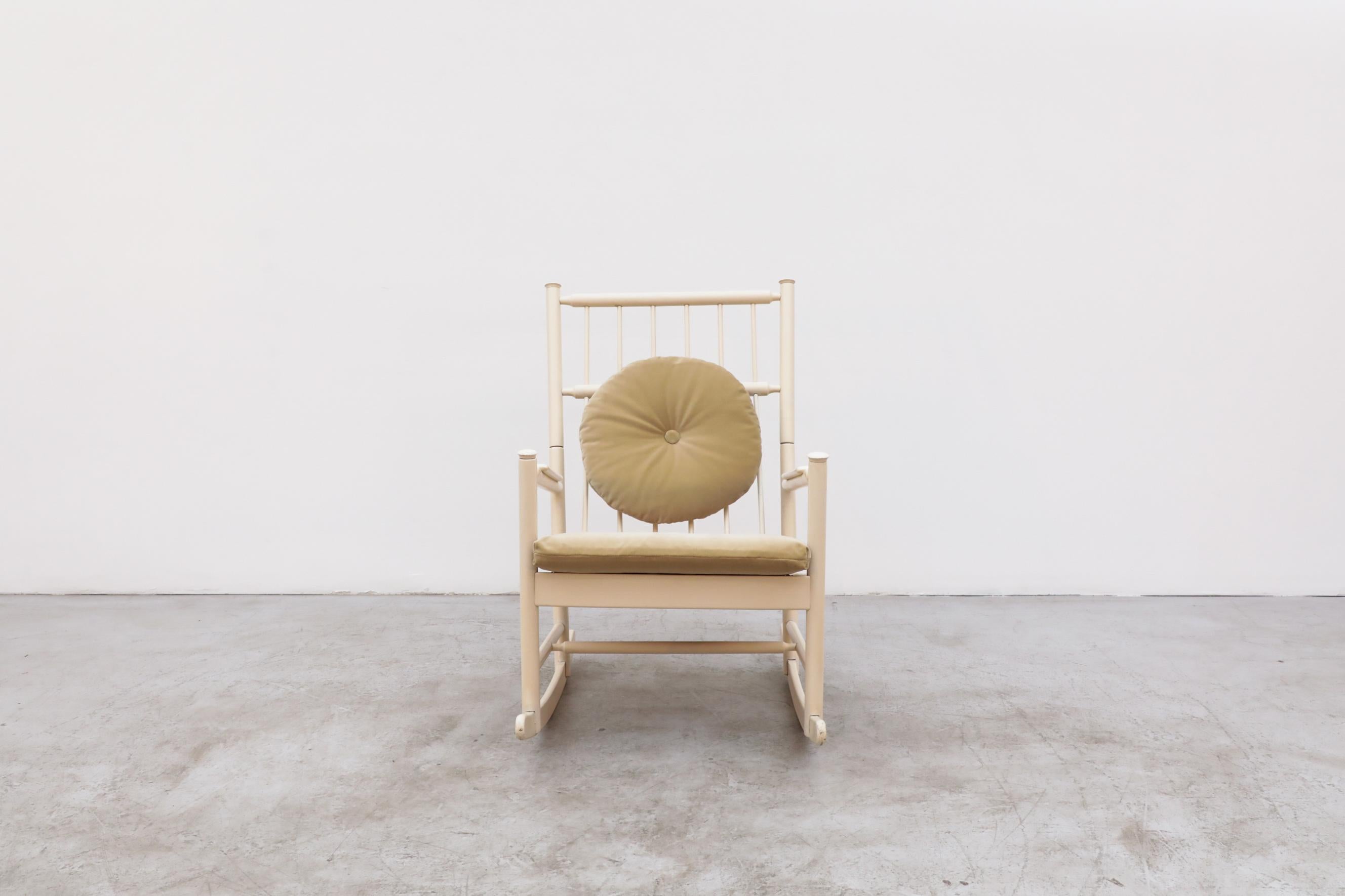 Tapiovaara style rocking chair with spindle back and lacquered off-white / cream wood. Newly upholstered gold velvet cushions, frame is in good original condition with visible wear, consistent with its age and use.