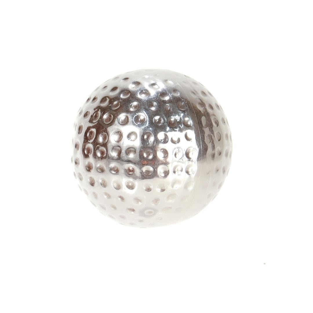 A fine Mexican pillbox.

In sterling silver.

In the form of a golf ball.

Marked to the interior with Mexican hallmarks including TV-50 & Sterlng.

Simply a wonderful golf-themed box!

Date:
20th Century

Overall Condition:
It is in overall good,