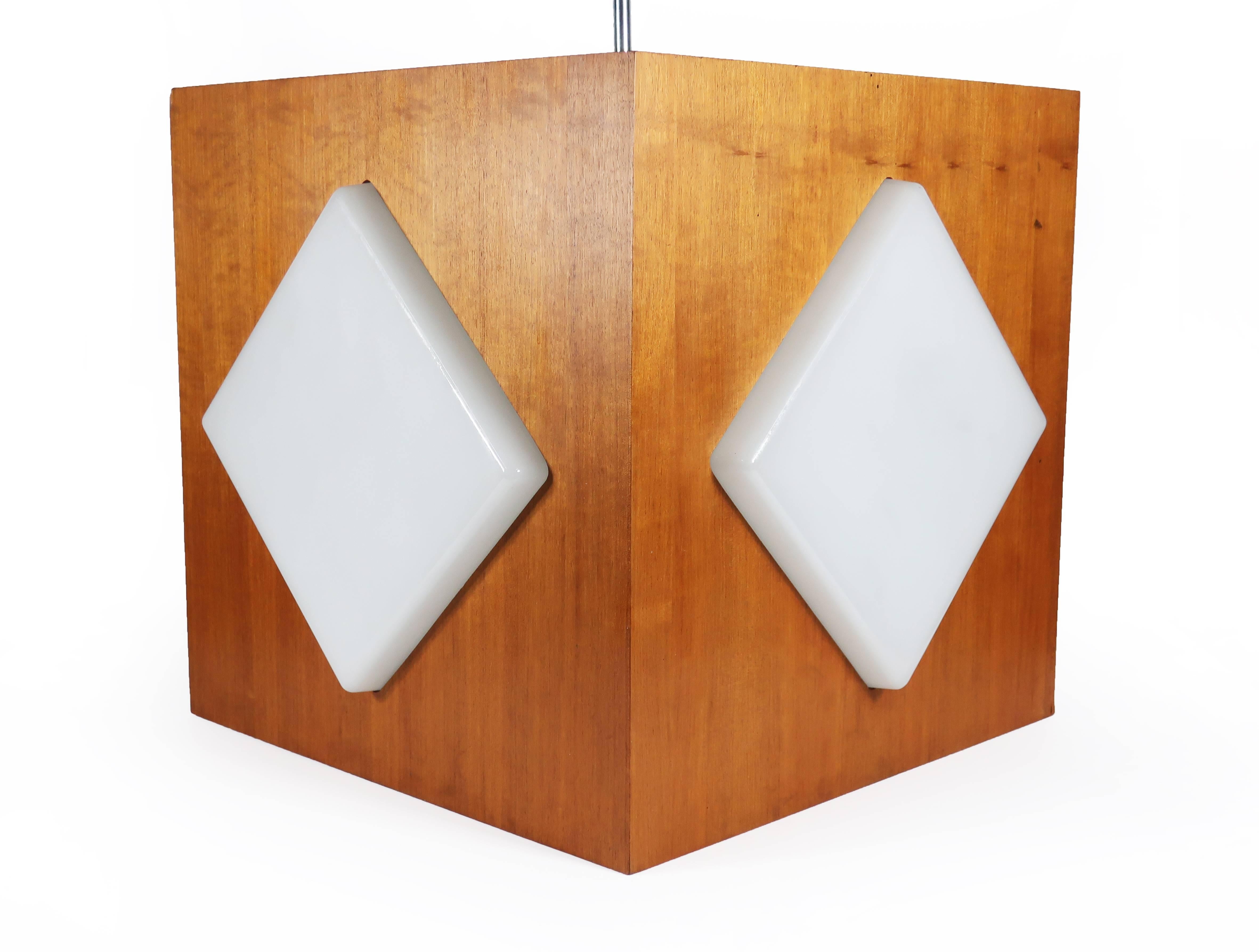 This Mid-Century Modern pendant lamp may just be big enough to be called a chandelier. With a beautiful teak frame on a chrome stem with frosted glass inserts around the four sides and bottom, this vintage pendant is large enough to provide light