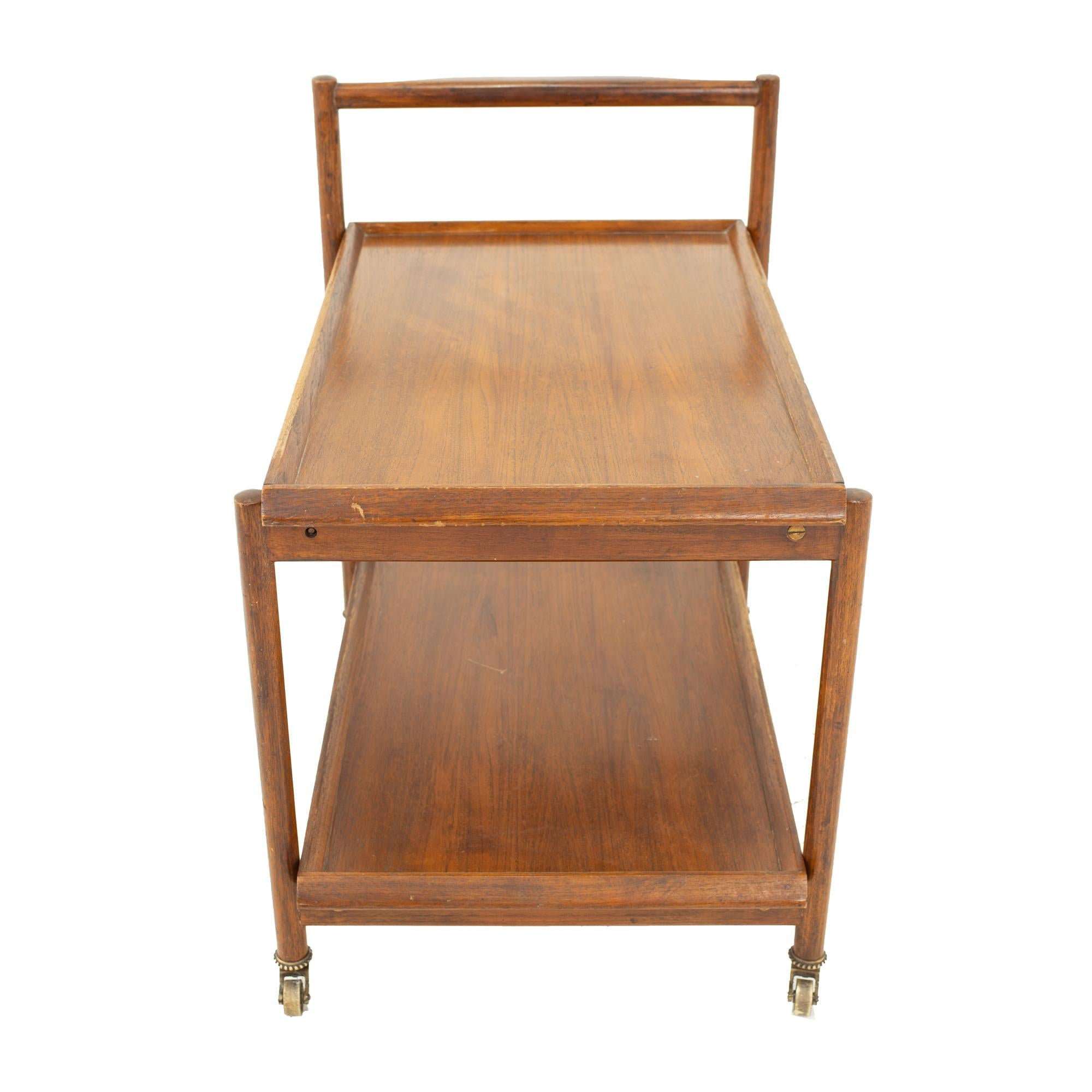 Mid Century teak 2-tier bar cart
Bar cart measures: 21 wide x 30 deep x 29.5 high

All pieces of furniture can be had in what we call restored vintage condition. This means the piece is restored upon purchase so it’s free of watermarks, chips or