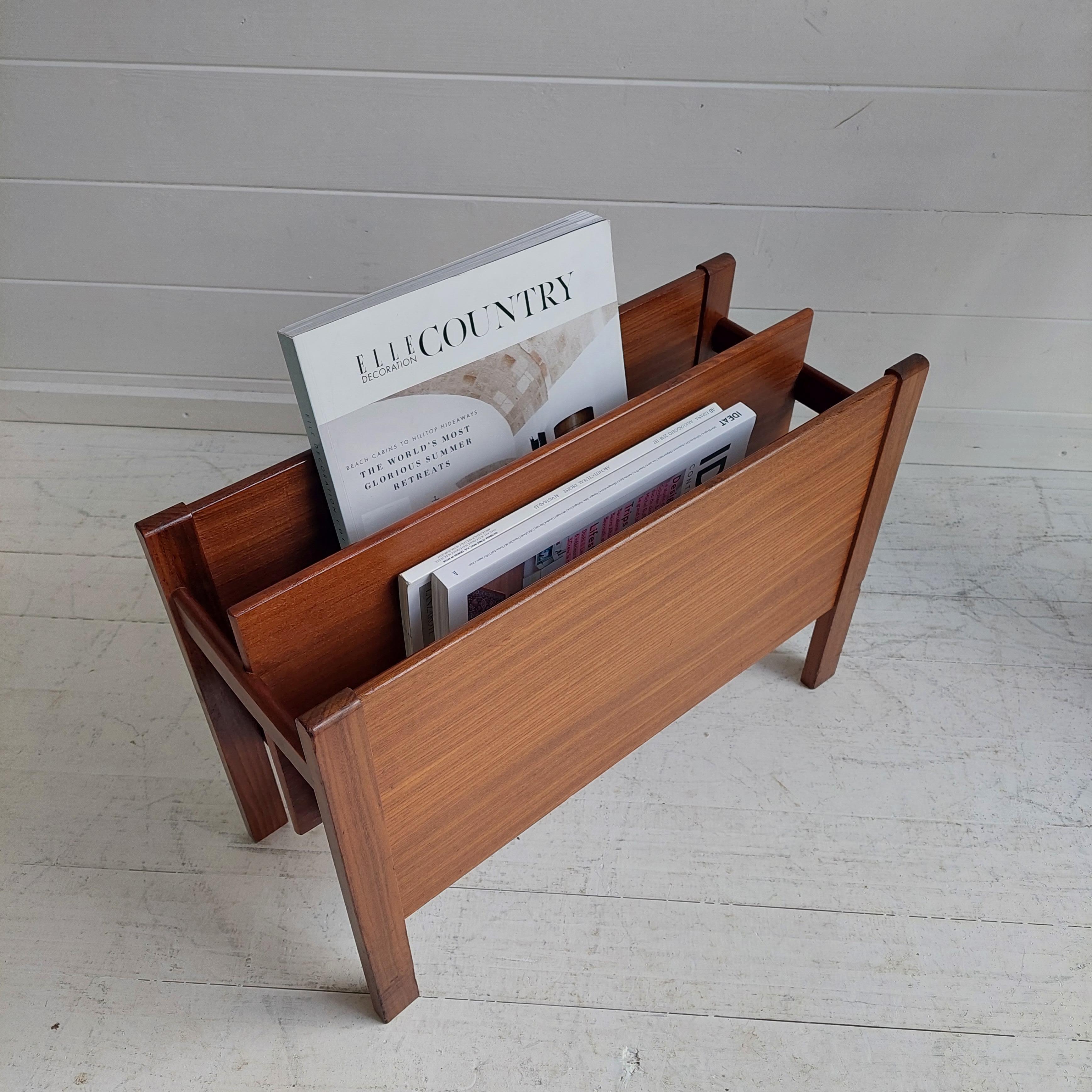 Mid-century teak magazine rack. 
Usually saud that was Designed by Guy Rogers, the 'Canterbury' magazine rack was made for Heals department store in the 1960's, but could be by Fyne Ladye Furniture ( Henry Stone ).

A minimalist design,