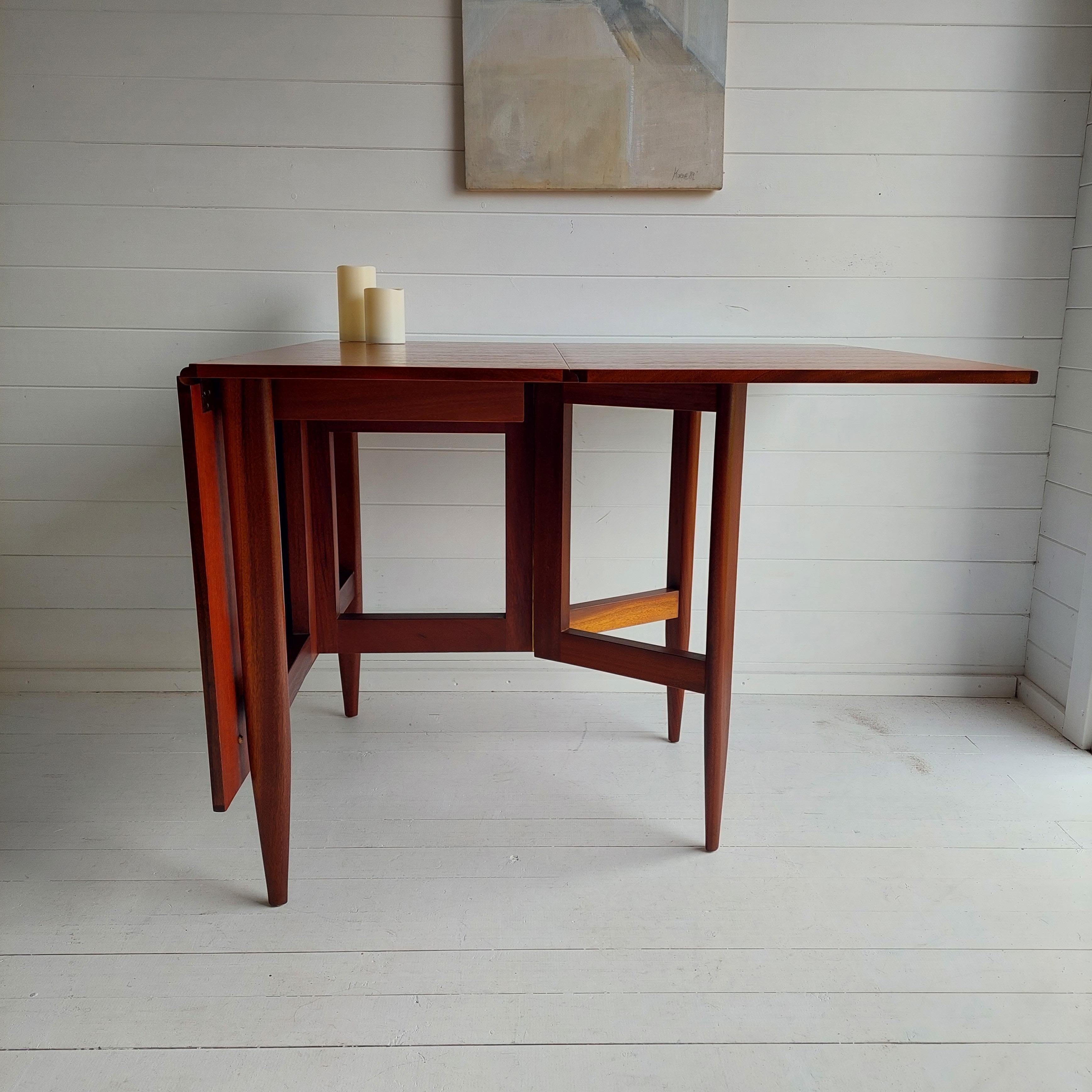 Unique Danish spacesaver gateleg dining table, circa 1960/70s

In the style of George Nelson model 4656, for Herman Miller in 1946, and 1955's design by by Peter Hvidt & Orla Mølgaard for France & Søn.
This example updated a classic form — which