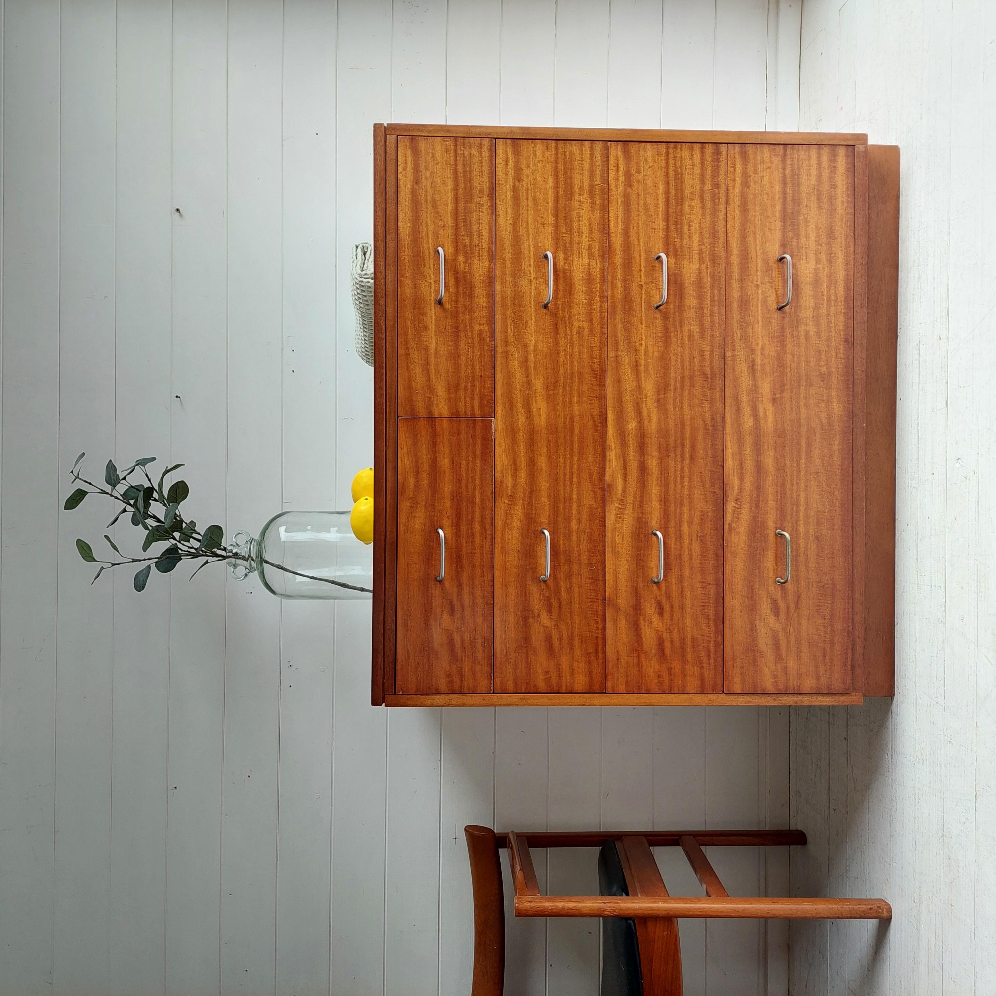 This delightful chest of drawers was designed and manufactured  probably by British firm Remploy in the mid-twentieth century. 
Originally purposed for use in the British Military accommodation. 
The chest has beautiful original metal handles, a