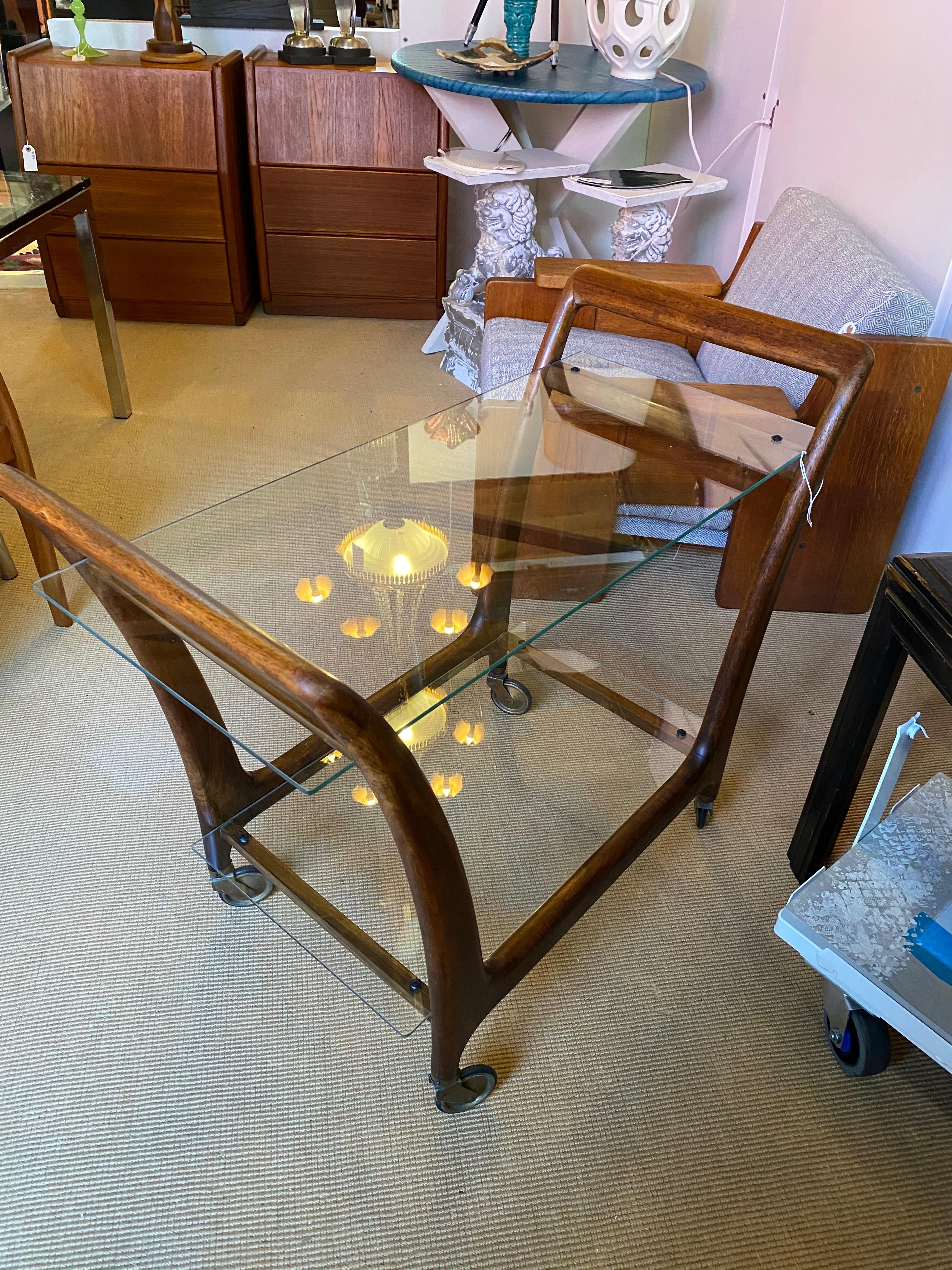 Mid century teak and glass bar cart. Great scale and form. Pristine condition.