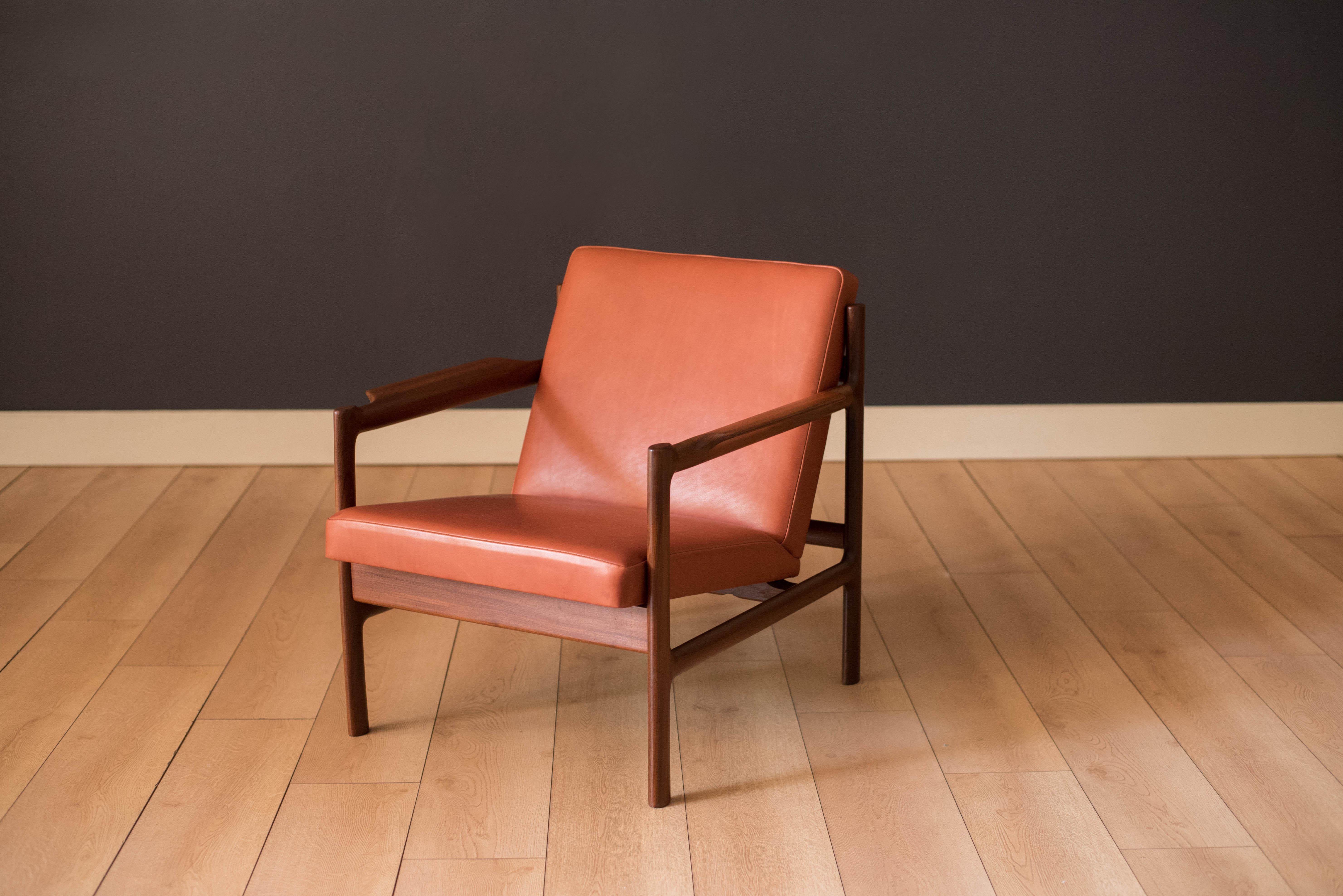 Mid-century lounge chair in old growth teak manufactured by Bruksbo in Norway. This piece has been professionally reupholstered in a rust red mahogany leather and features unique curved arm rests and sculpted legs.




Offered by Mid Century Maddist