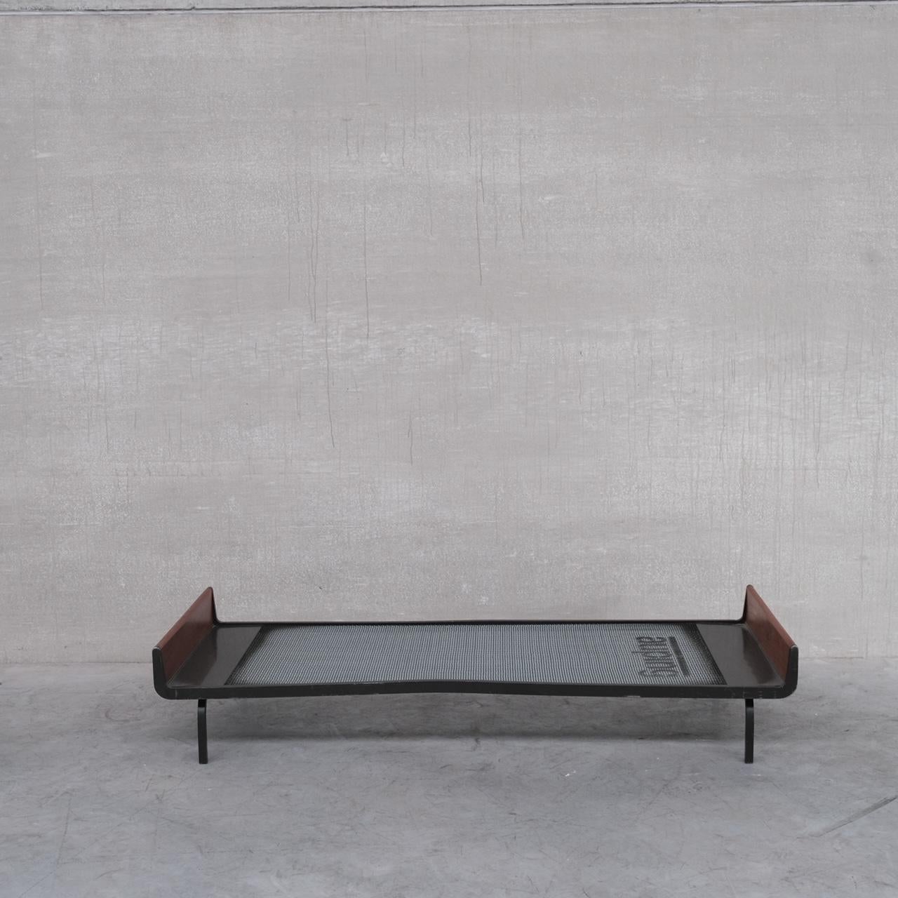 A stylish teak and metal day bed by Friso Kramer for Auping. 

Holland, c1950s.

Easy to purchase a mattress or get a custom made cushion made to taste. 

A small ding/bend in the left hand side of the frame. It does not affect the