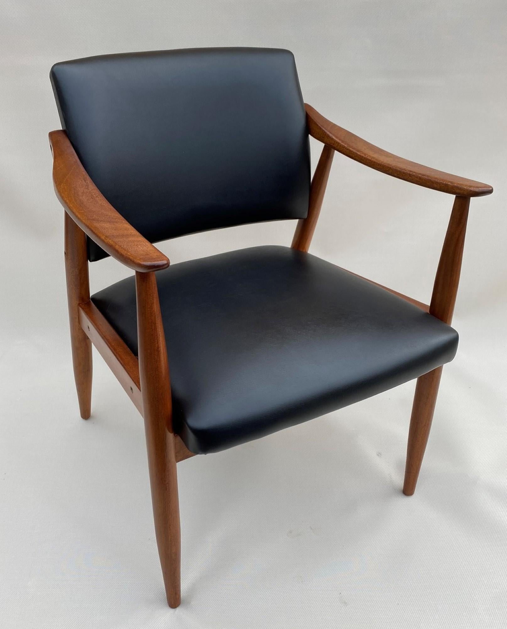 Midcentury teak armchair. Solid teak frame, black leatherette upholstered seat and back rest. Elegant tapered legs, and armrests.

Teak frame has been refinished.

Scandinavian, 1960s

Condition: Great condition.

Dimensions: Overall: 58 Cms