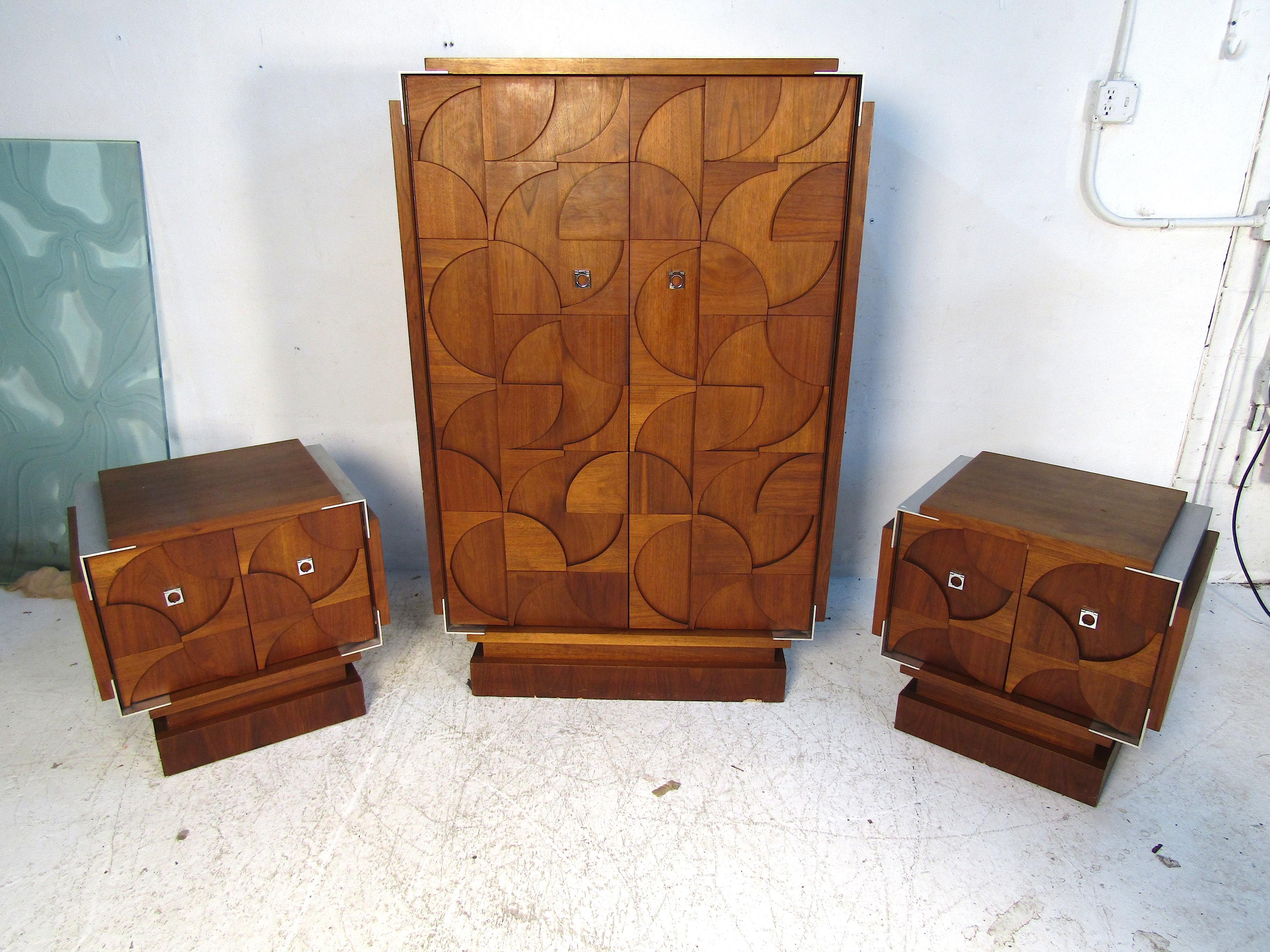 This beautiful and unique bedroom set features an intricate design on the facade. The armoire has ample storage with multiple drawers and cabinet sections. The two smaller nightstands have the same beautiful workmanship on the front, and all three