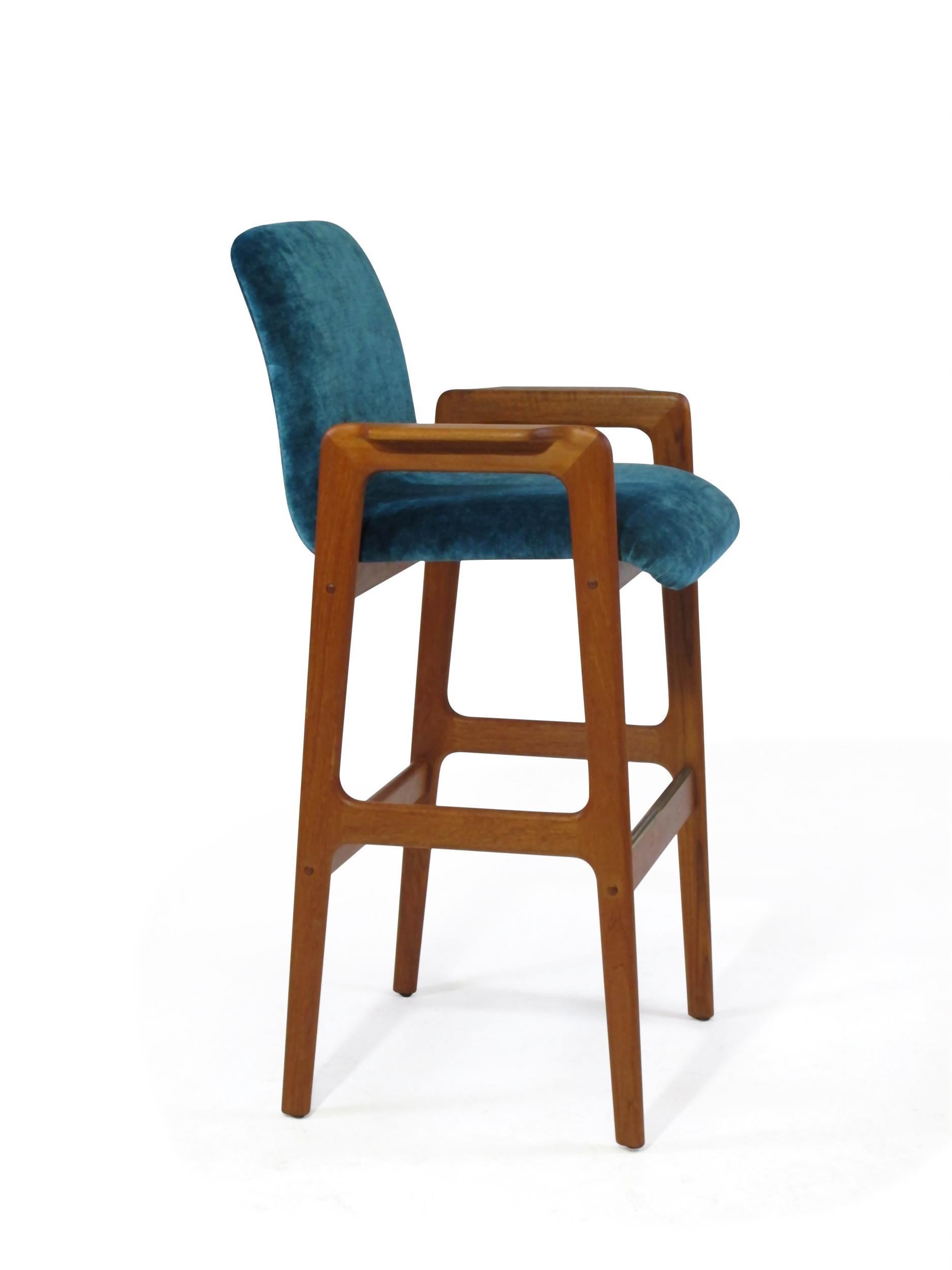 Midcentury teak bar stools, circa 1970, crafted of solid teak frames with armrest newly upholstered in a turquoise velvet.