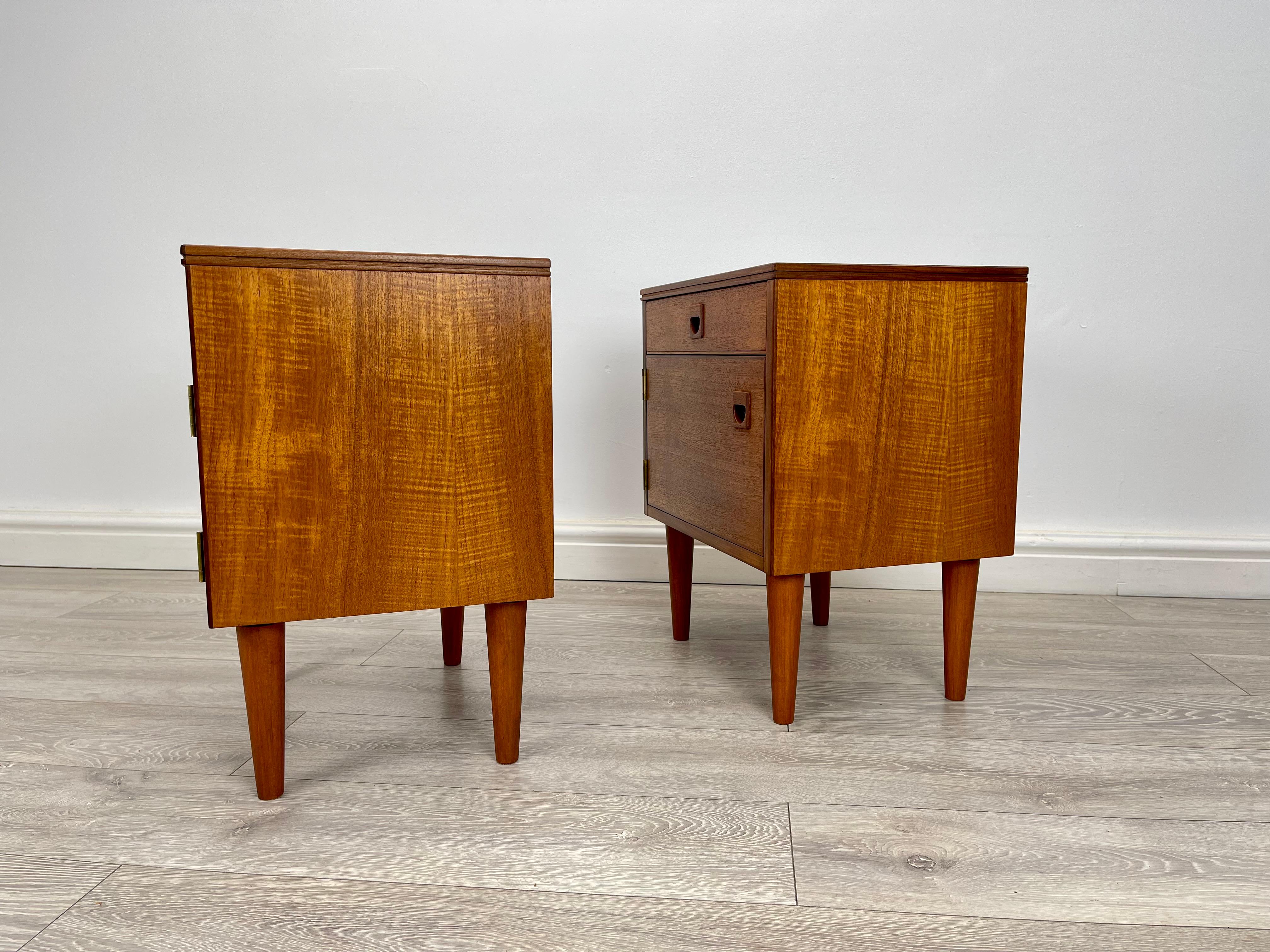BEDSIDE TABLES 
Stunning pair of Midcentury teak bedside tables made by Alfred Cox Circa 1960 . The bedsides have stunning grain and golden patina throughout . 

They stand on round tapered legs with single drawer and small cupboard below fitted