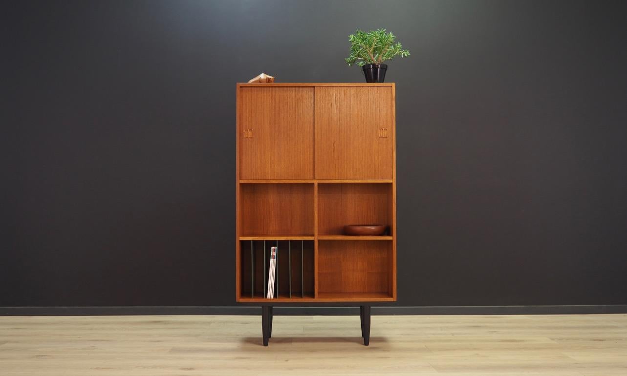 Bookshelf from the 1960-1970, Scandinavian design. Practical bookshelve finished with teak veneer, with partitions and sliding doors. Preserved in good condition (minor scratches) - directly for use.

Dimensions: Height 144.5 cm width 87.5 cm