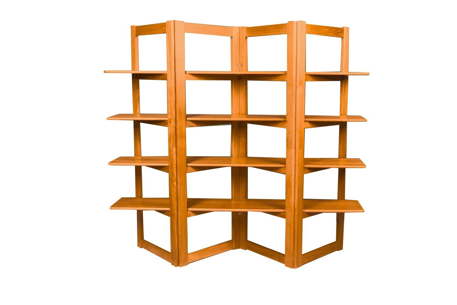 A remarkable 4 shelf bi-fold Mid-Century Modern, freestanding, Room Divider /open Bookcase, in nearly pristine condition. Manufacture By Sun wood Industries by KD Furniture. Lovely double-sided teak tones and grain on both sides in a beautiful rich