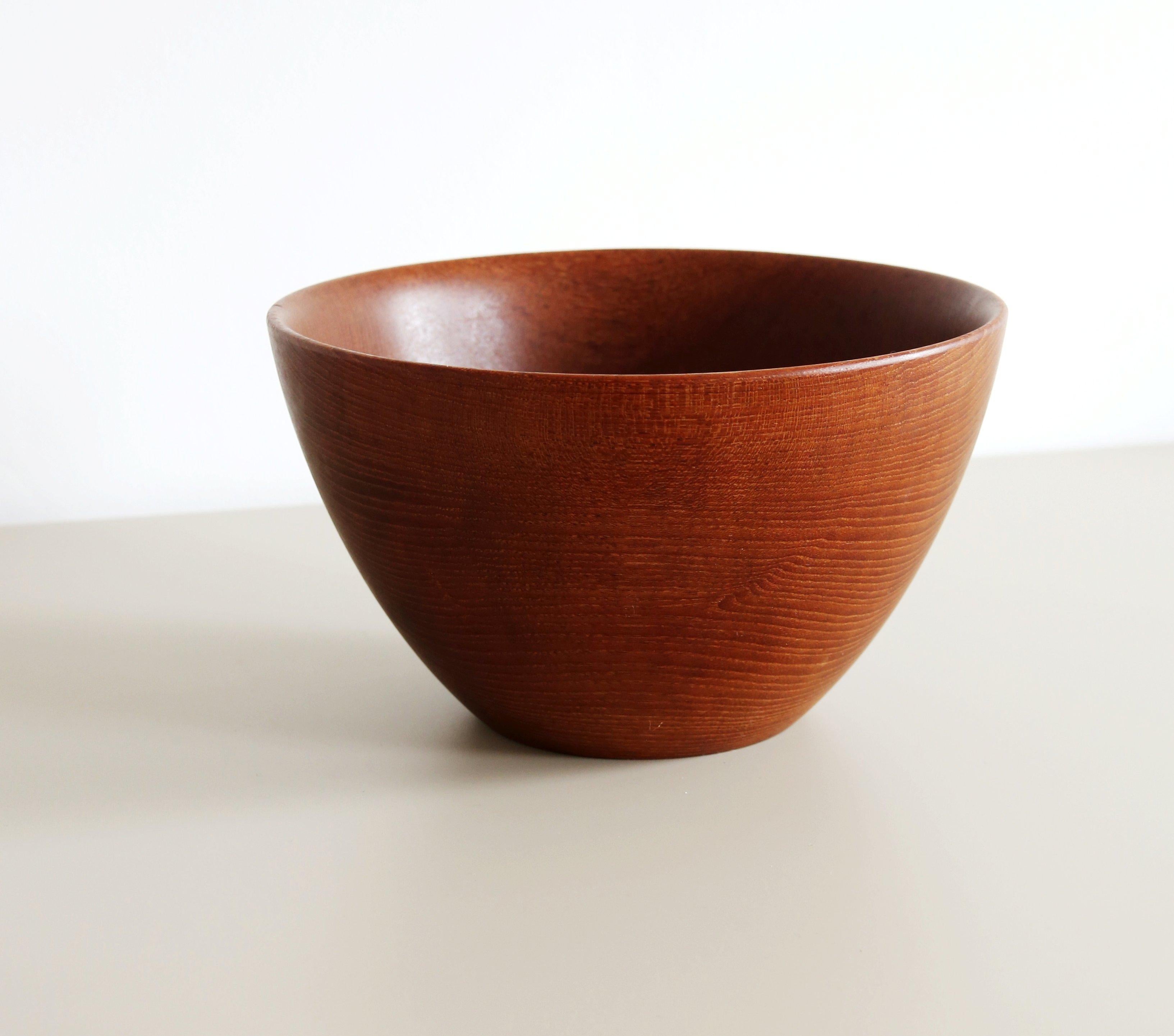 Mid Century teak bowl by Galatix hand made in England from Burmese teak

Lovely large wooden bowl with a beautiful grain and patina in lovely vintage condition for a useful and practical item that is over 50 years old, it dates from the
