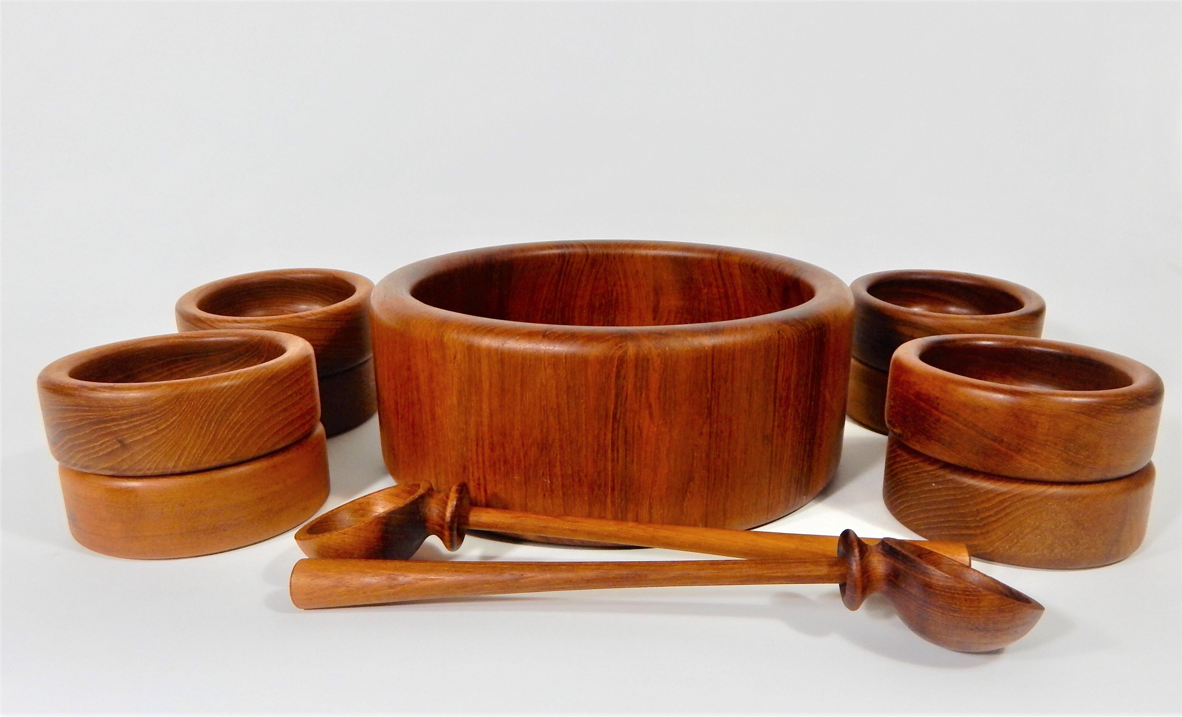 Midcentury 1960s 11-piece Teak Bowl or Salad set by Nissen, Denmark. 
Serves eight. Entire set is made of teak. Entire set is in excellent condition.
Measures: One large bowl 12 x 5
Eight small bowls 5.5 x 2
Two unique utensils 13 x 2.75 x 2.5.