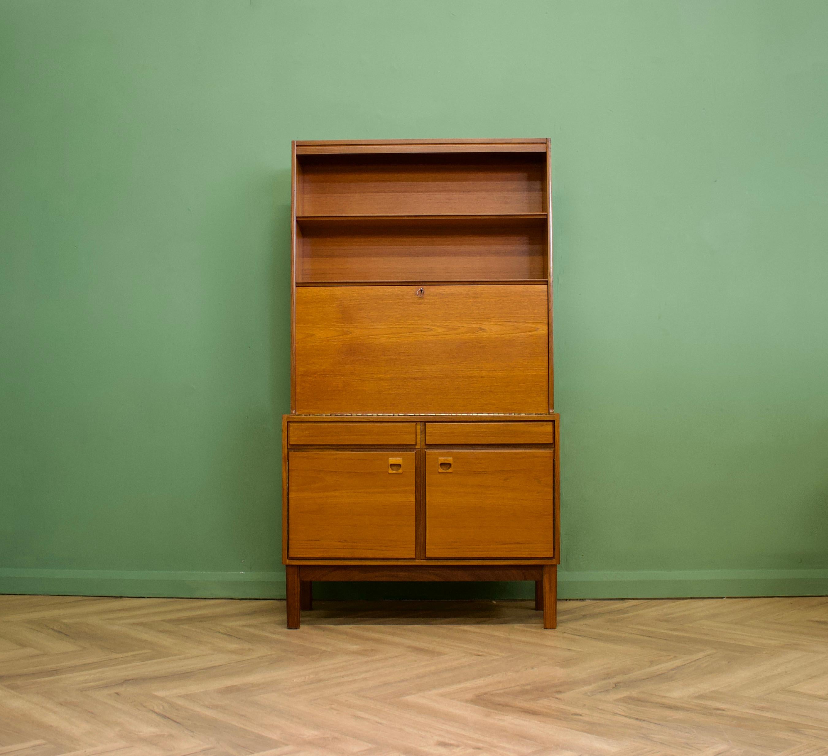 A mid century teak bureau bookcase from Vanson, circa 1960s

The piece is quality made - featuring two shelves to the top and a pull down desk area with additional storage and shelving inside

Each of the two  drawer fronts are made from solid teak