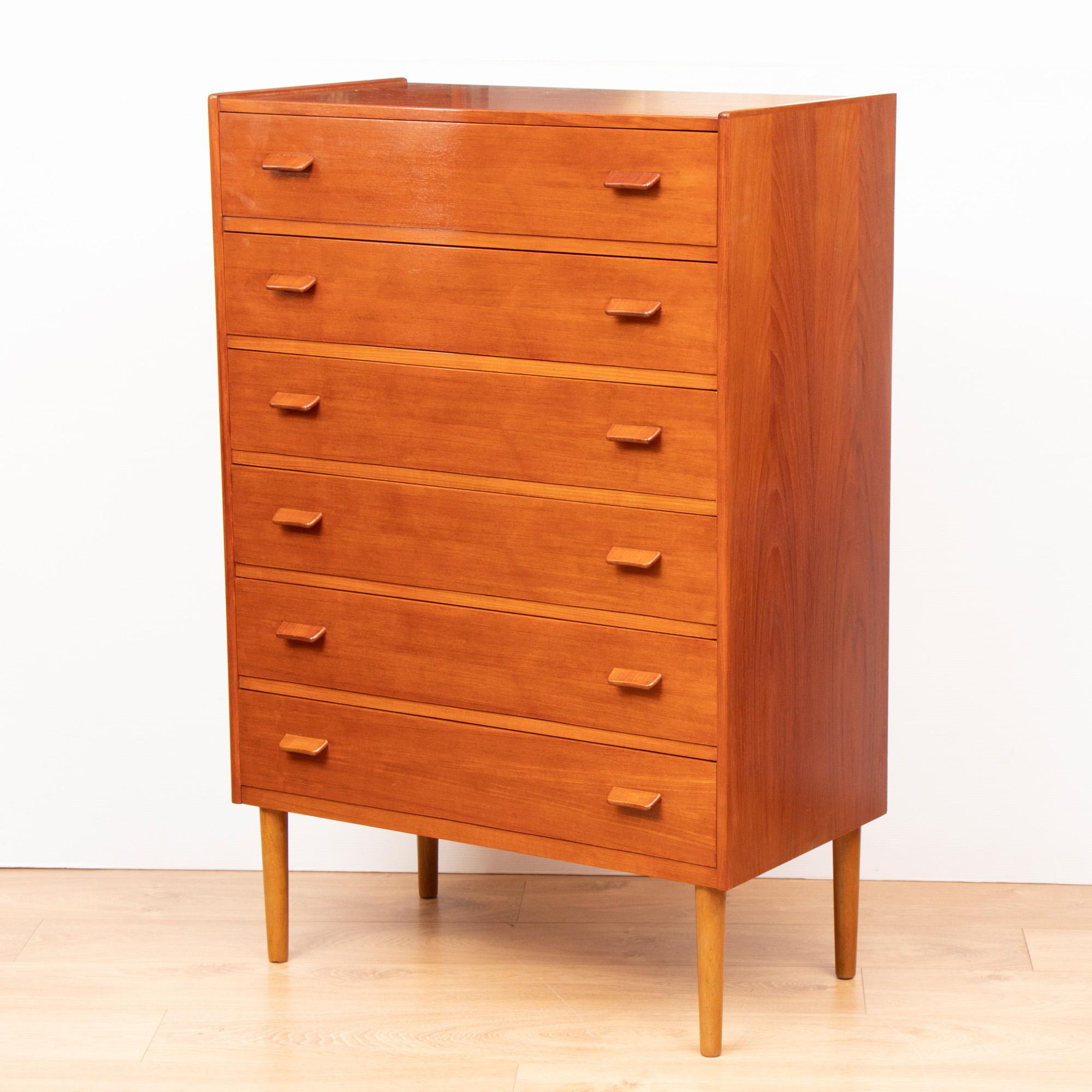 Midcentury teak chest of drawers with tab handles designed by Poul Volther for Munch Moller Slagelse and retailed by Heals of London, circa 1960.