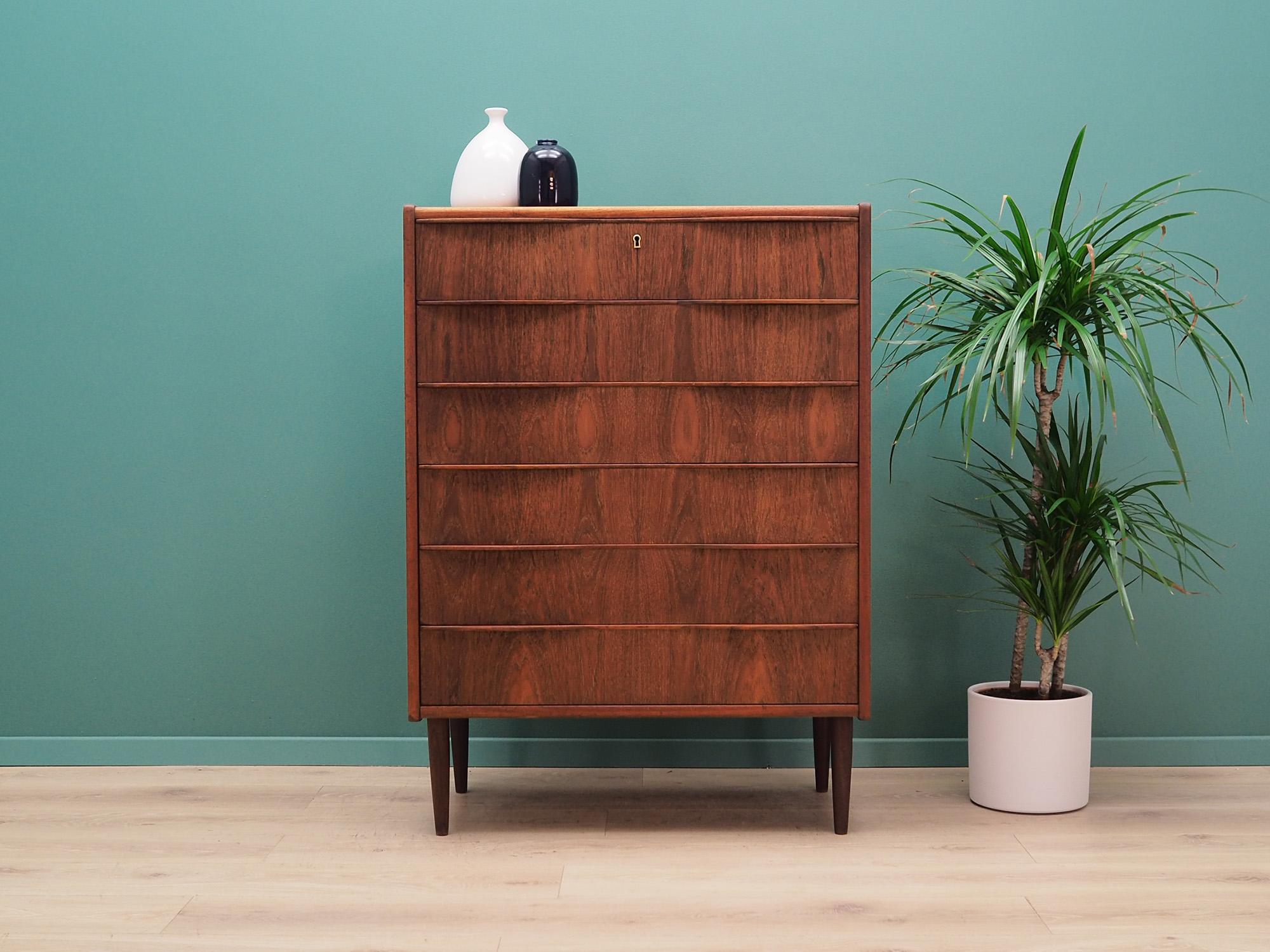 Excellent chest of drawers from the 1960s-1970s, Danish design, Minimalist form. Surface of the furniture is covered with teak veneer, legs are made of solid teak wood. Furniture has six elegant drawers, no key included. Preserved in good condition