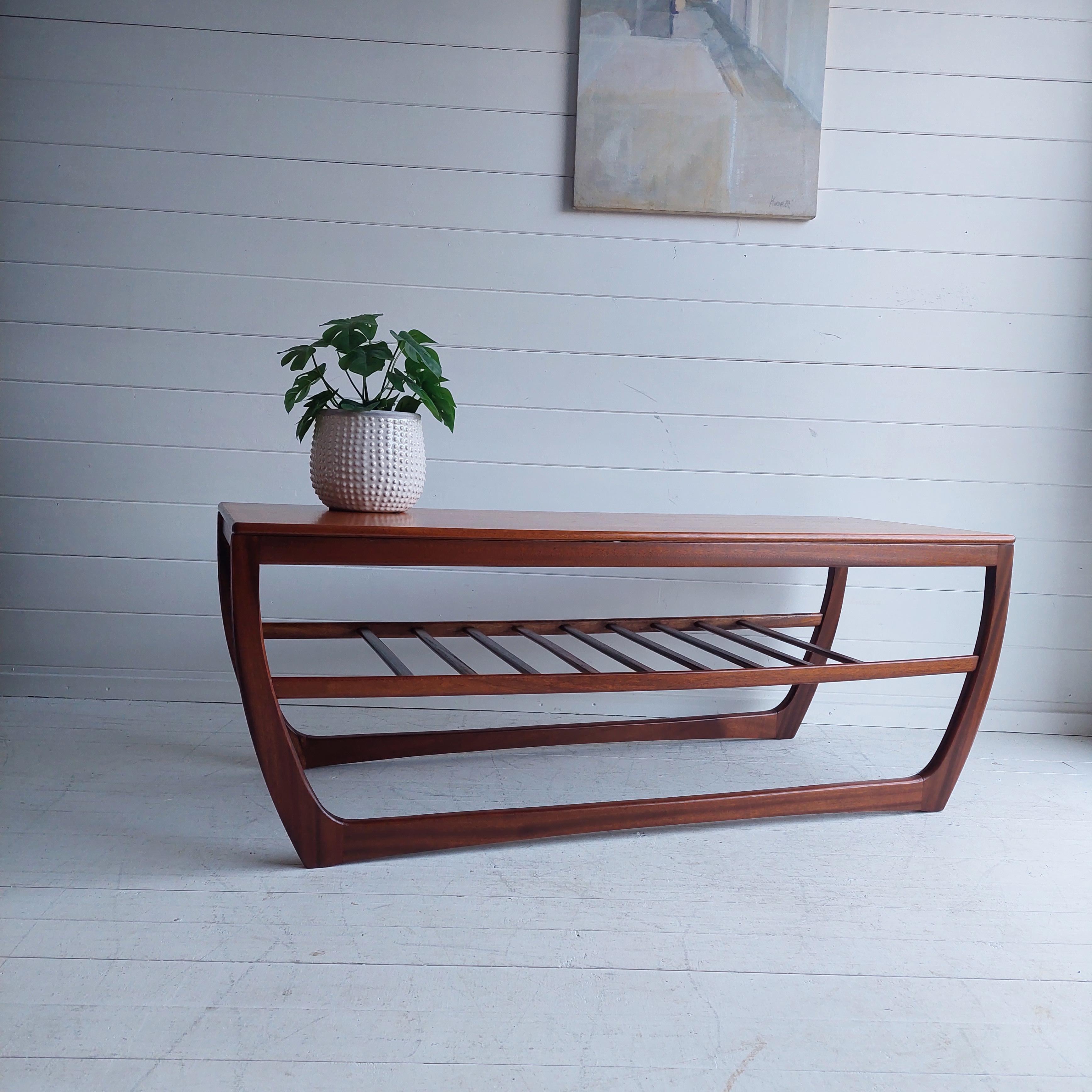 A stylish and practical vintage teak and afromosia coffee table by Beithcraft Furniture of Scotland.

Stunning and rare coffee table made in Uk during the 60s
Afromosia frame and under shelf with a nice teak top
The shape is just unique.
Sleight
