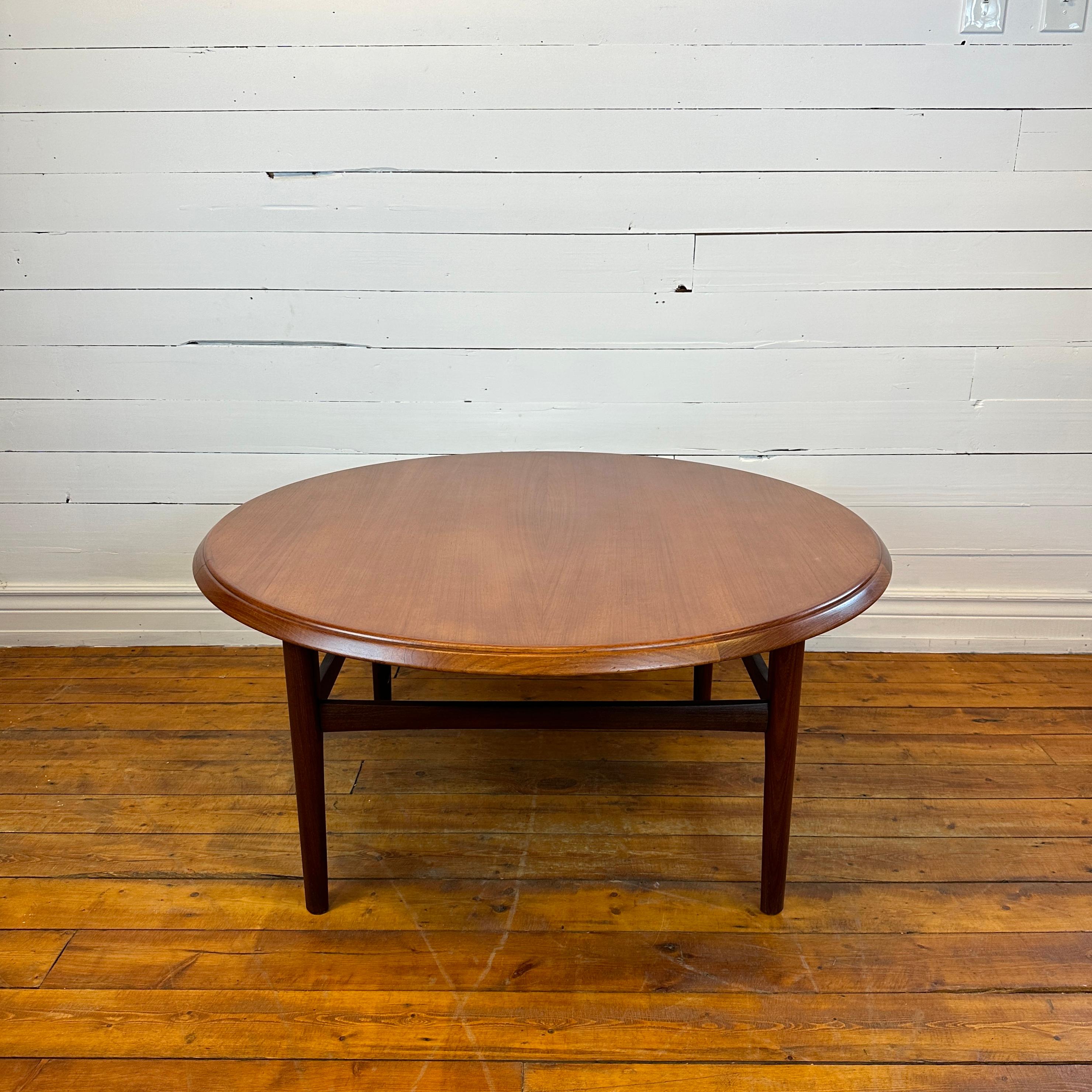 Condition: Refinished Surface

Dimensions: 41” D x 18.75” H

Description: A great quality teak coffee table. Made in Norway, Circa 1960s-70s. Great condition with a new lacquer finish on surface. Solid teak base and banding.