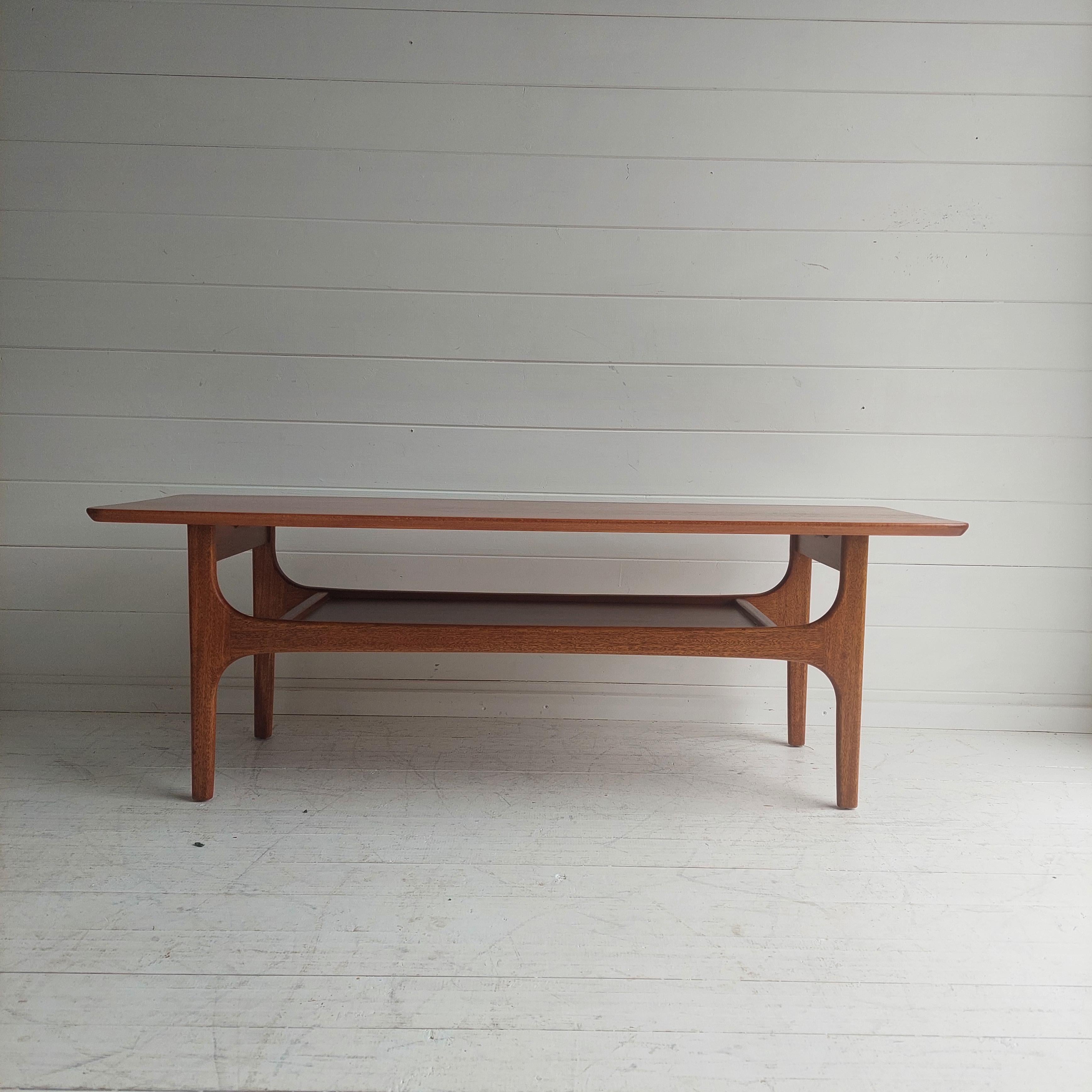 Stunning mid 20th century coffee table by Jentique (Model - Stingray, c.1960). 

Crafted from quality teak and beech with captivating grain detailing and beautiful sculptural joinery. 
A two tier coffee table with fabulous form, featuring a long