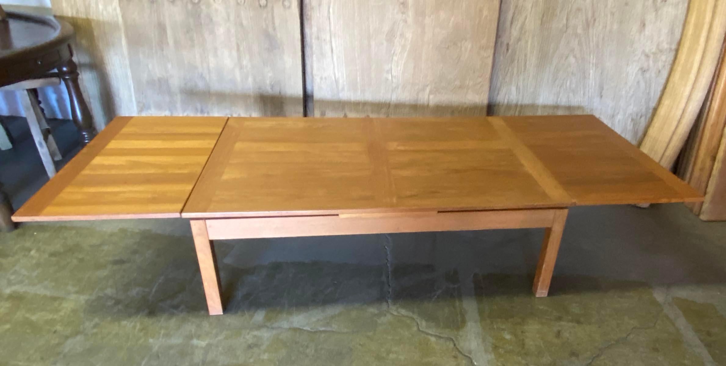 Teak veneer coffee table that extends to 93 inches long with extensions on each side. Vintage condition with a few scuffs but still great!