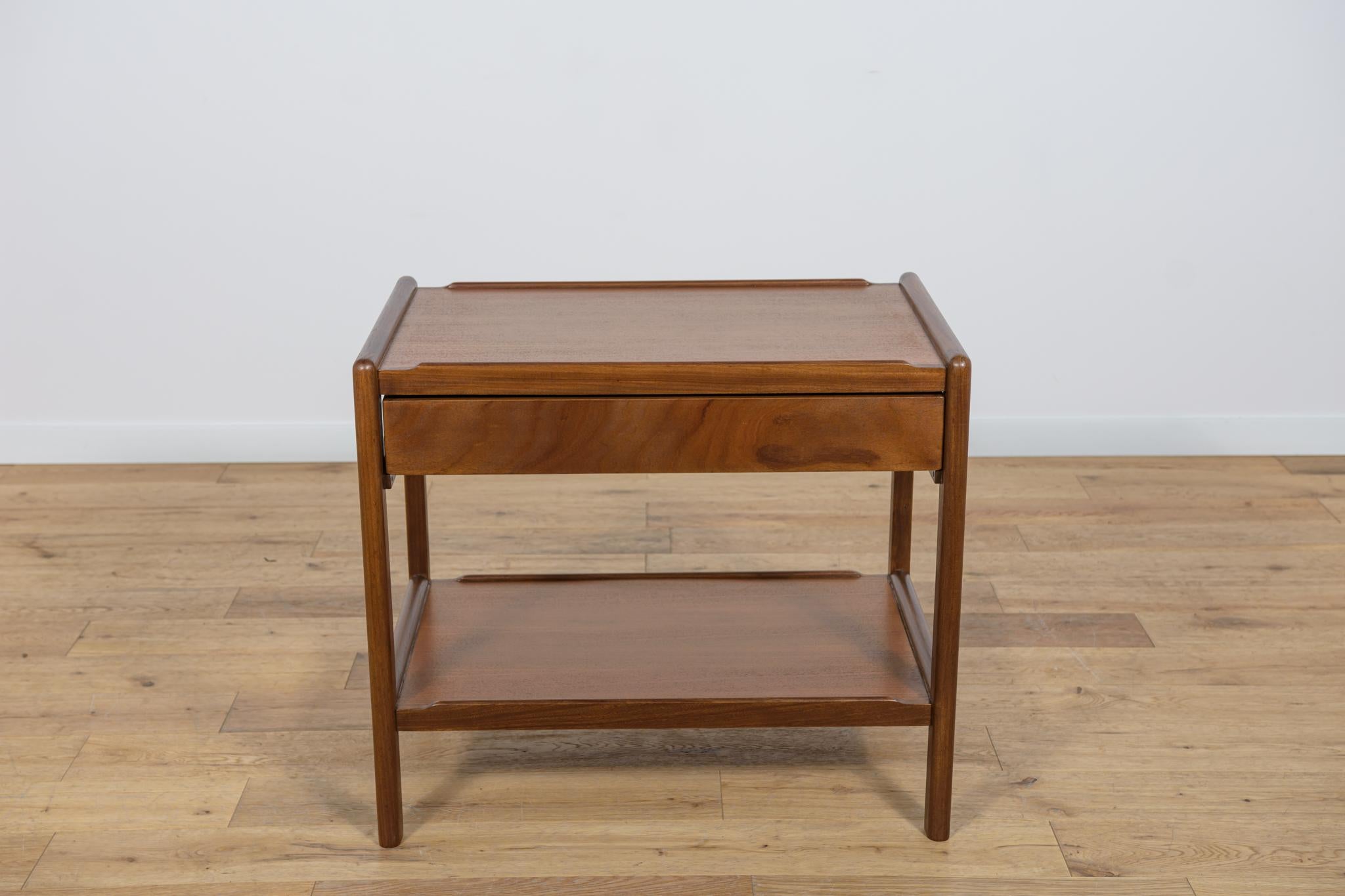 Console made in Denmark in the 1970s. Made of teak wood, with a shelf in the lower part and a drawer in the upper part. It has been thoroughly renovated, the wood has been cleaned of the old coating, painted with oak stain, and finished with a