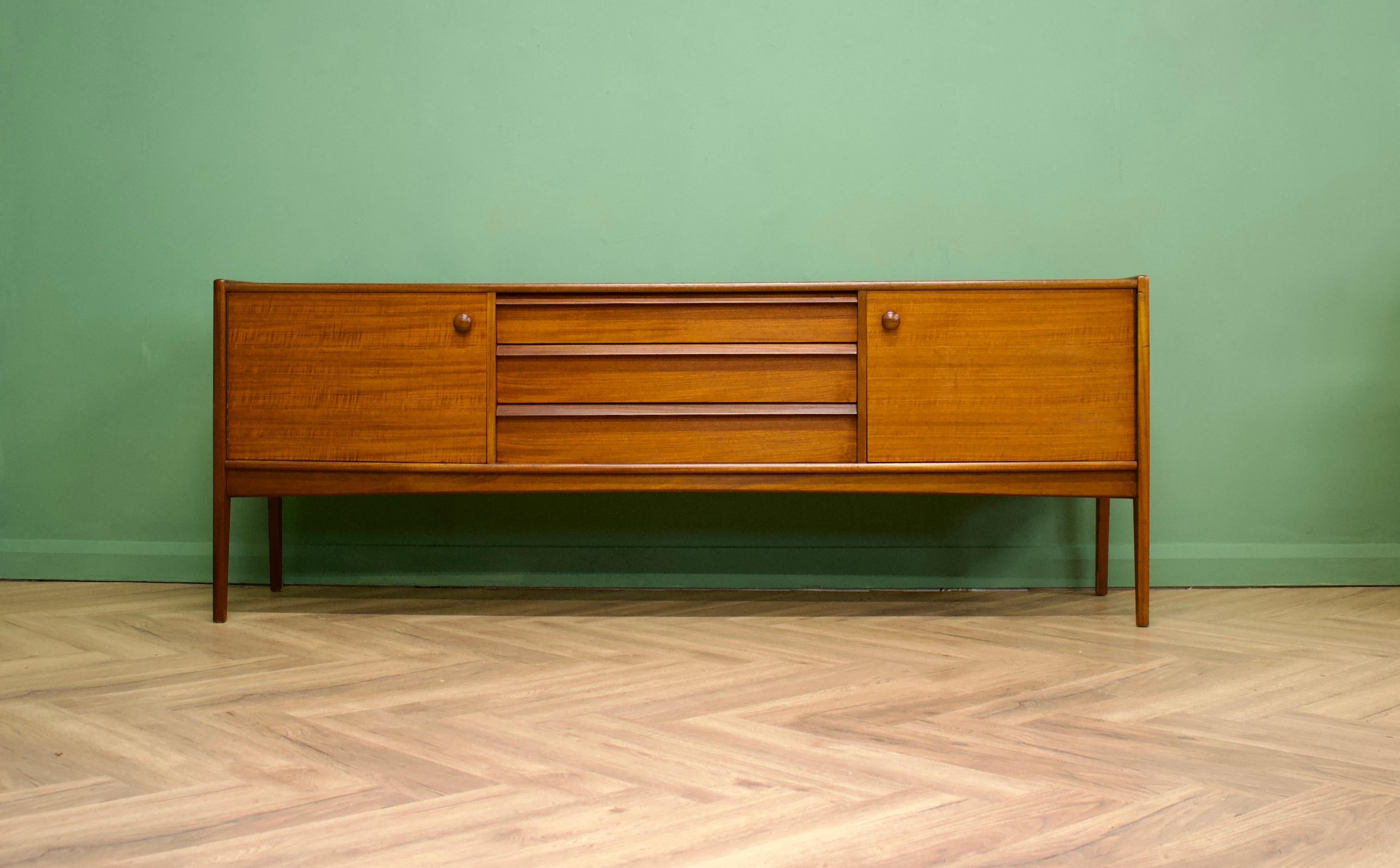 -- Mid-Century Modern sideboard
- Manufactured in the UK by Younger
- Designed by John Herbert
- Made of teak and afromosia and teak veneer
- Features three drawers, with room for cutlery in the top, and two
cupboards.