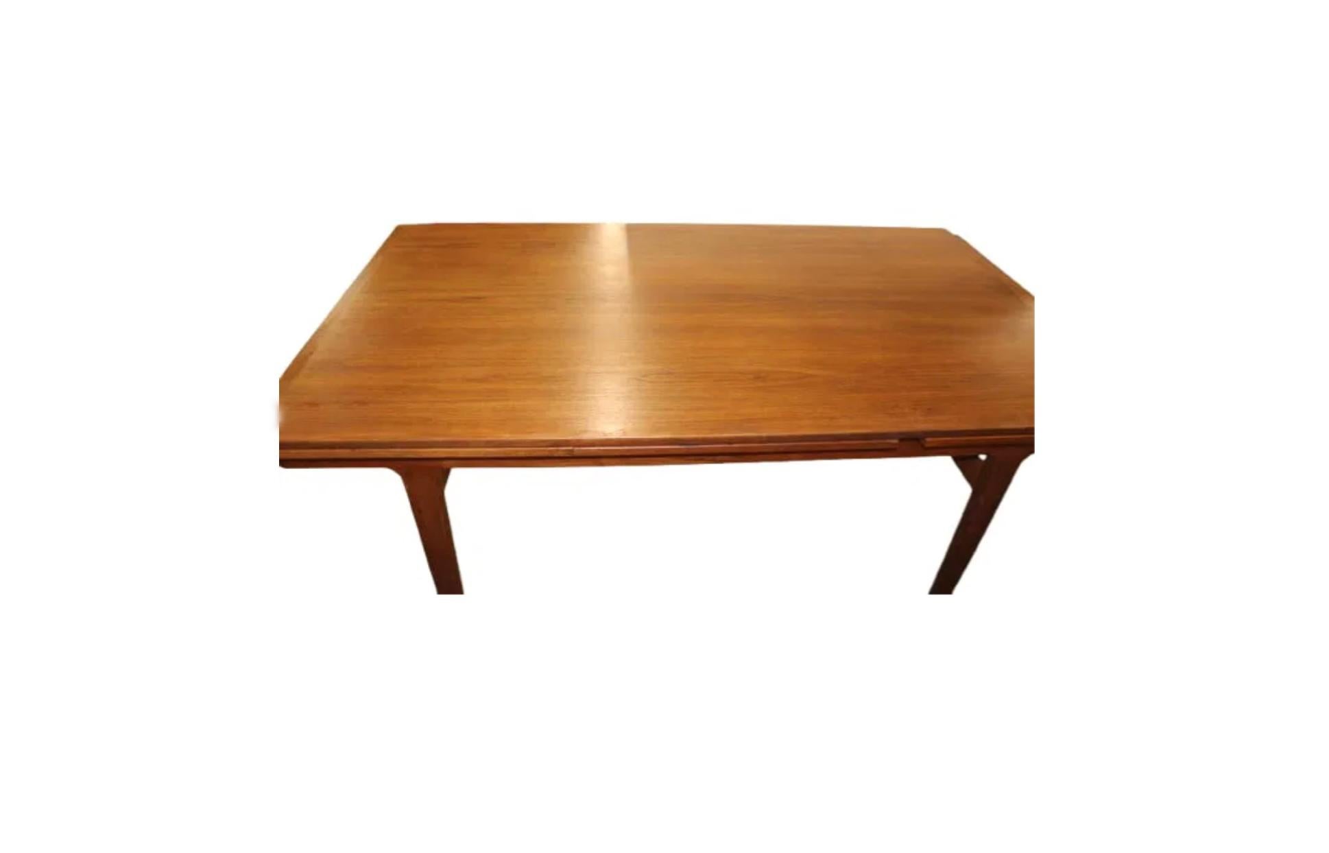 Mid century Teak Rectangle Danish Modern extension dining table with (2) nesting pull out leaves. This table has Solid teak apron and tapered legs. This table is in beautiful condition with medium brown and black teak tones. Great construction and