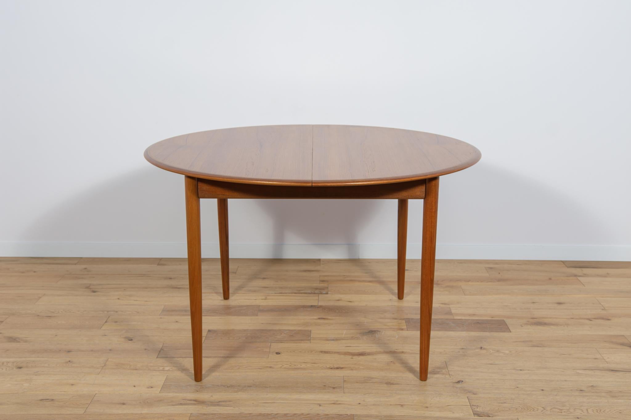 The round extendable table made of teak wood was produced in Denmark in the 1960s. The table has solid, profiled edges giving it an elegant, sublime shape. The table has been completely renovated, cleaned of old coatings, and finished with