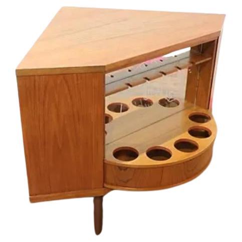 This fabulous mid century corner revolving secret bar is an fabulous an piece of furniture.  This is danish design and quality summed  up in one piece.  The Cabinet features an amazing revolcing drinks bar and display cabiney so you can eith display