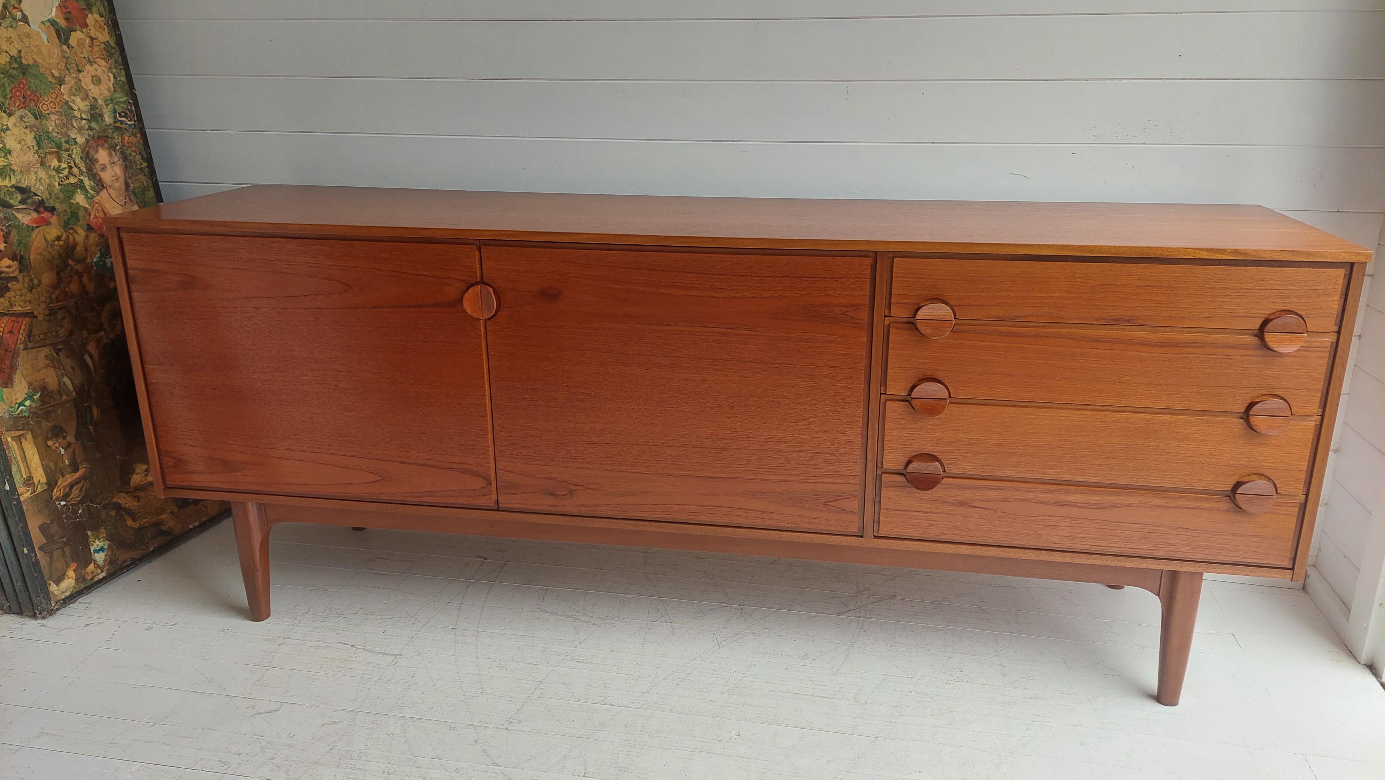 A simply stunning 1960/70s Nathan teak Danish style sideboard.
A very rare an scarcely seen. We have just been able to find a couple sold in the past and just with the compact version.
A very desirable piece, in excellent restored condition -